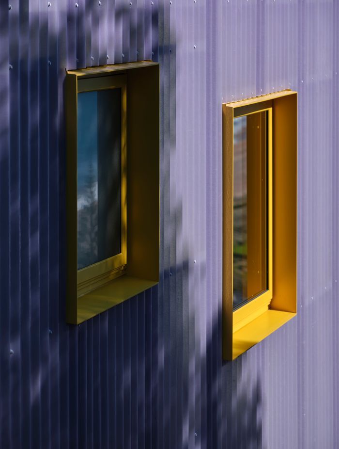 Windows in the building were very carefully considered to capture glimpses of the view. The powdercoated yellow joinery adds to the unconventional aesthetic.