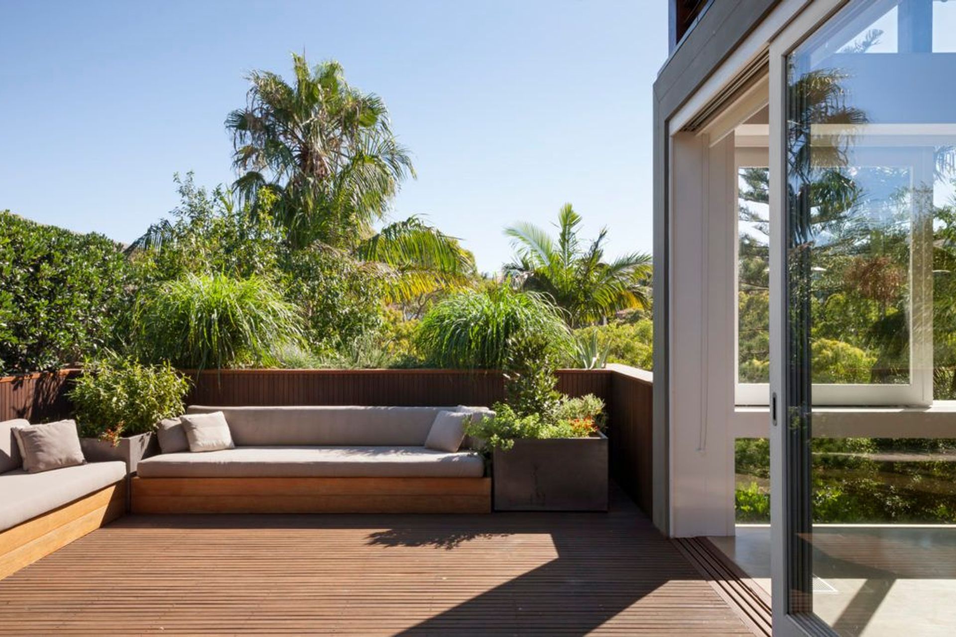 Large square lightweight pots on this balcony are filled with edible plants – the Parsley Bay garden – Pepo Botanic Design.
