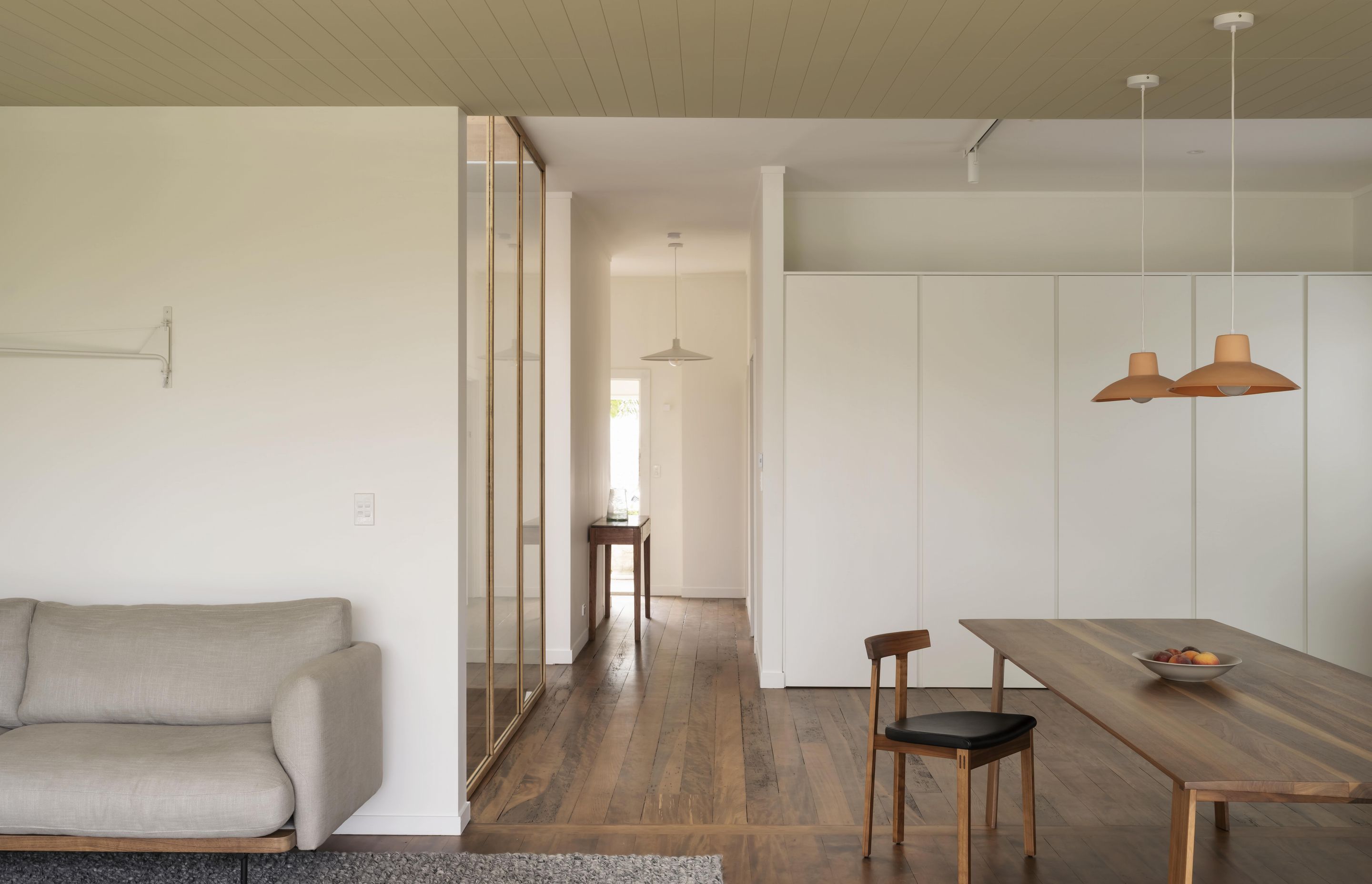 The original timber flooring adds a touch of warmth to the entryway and open-plan living area. Photo: David Straight