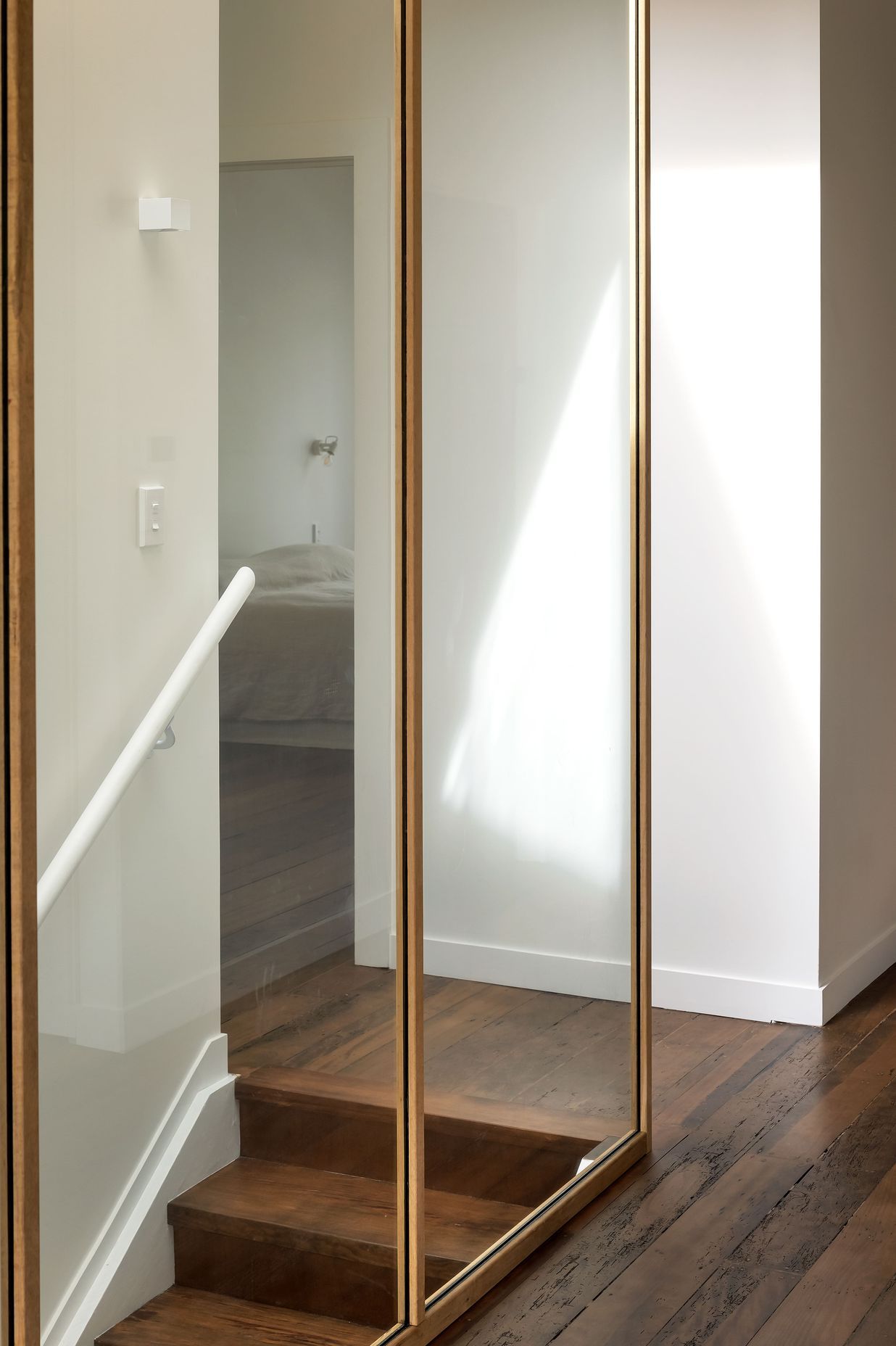 The stairwell skylight and glazing allow sunlight into the hallway. Photo: David Straight