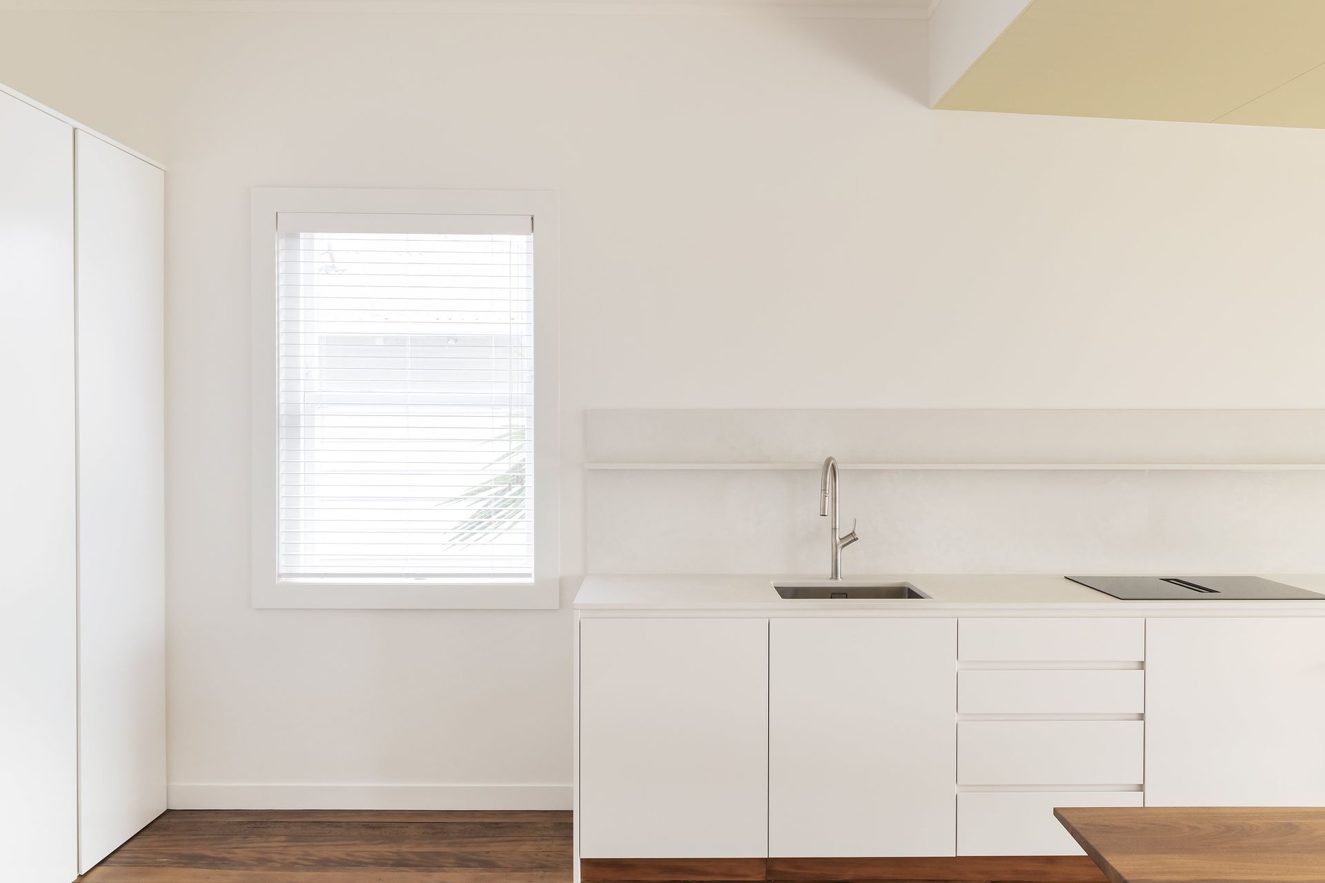 While minimal in design, the kitchen offers ample storage. Photo: David Straight