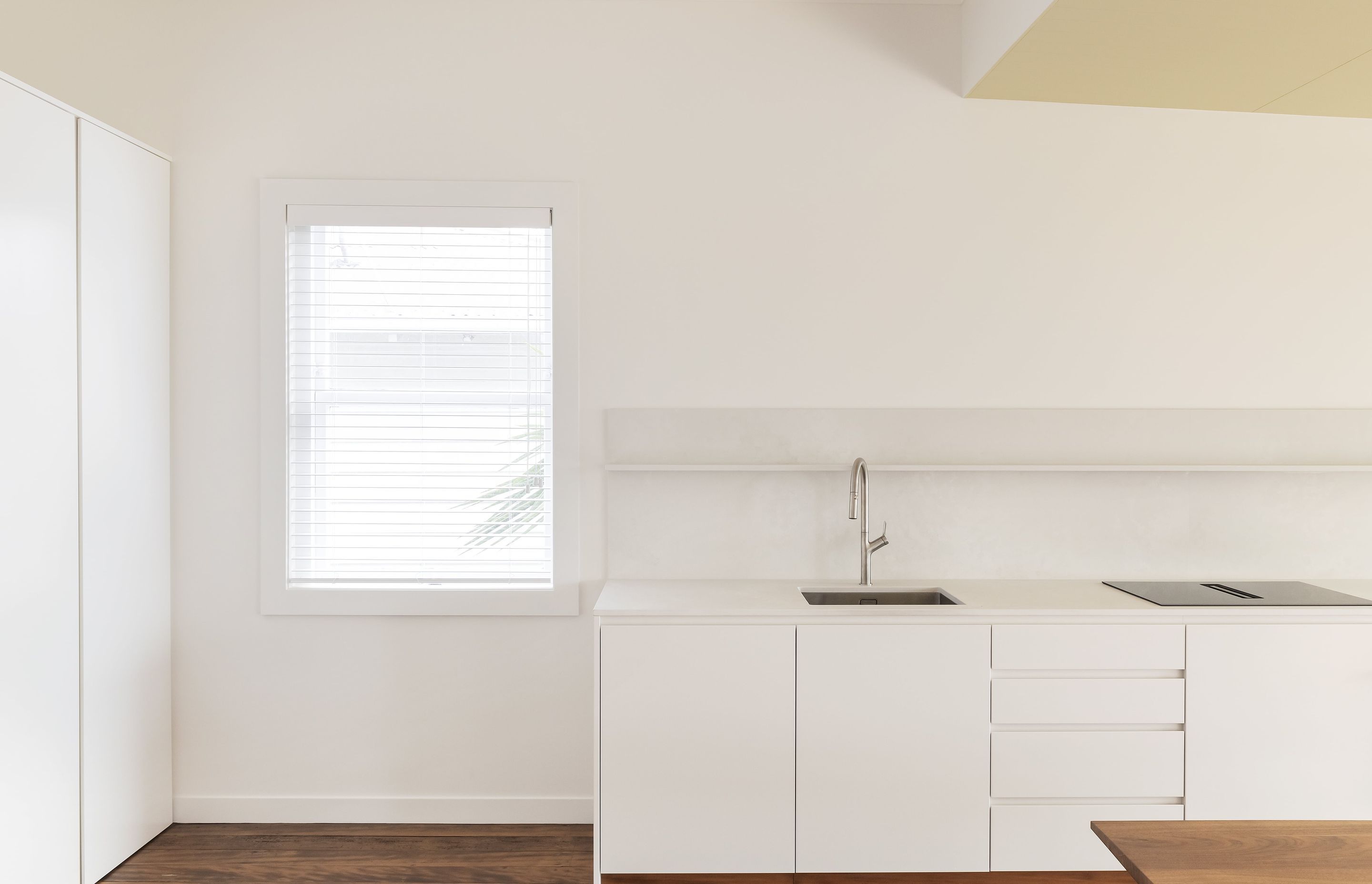 While minimal in design, the kitchen offers ample storage. Photo: David Straight