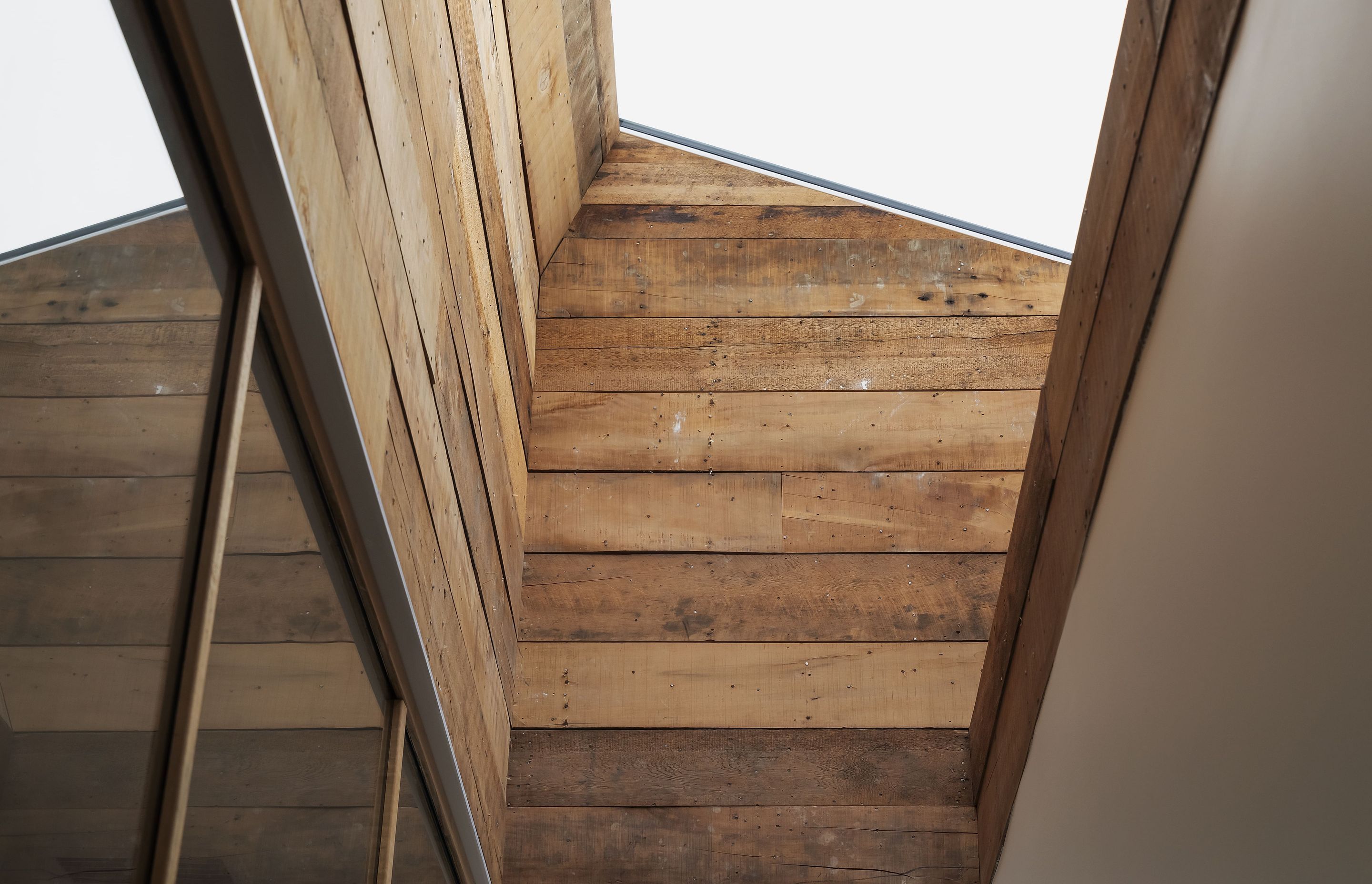 Kauri sarking rescued from an older part of the house clads the skylight shaft. Photo: David Straight