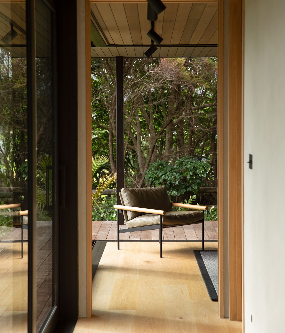 The guest room at the end of the bedroom spaces can be opened right up to the lush semi-tropical garden. Image credit: David Straight