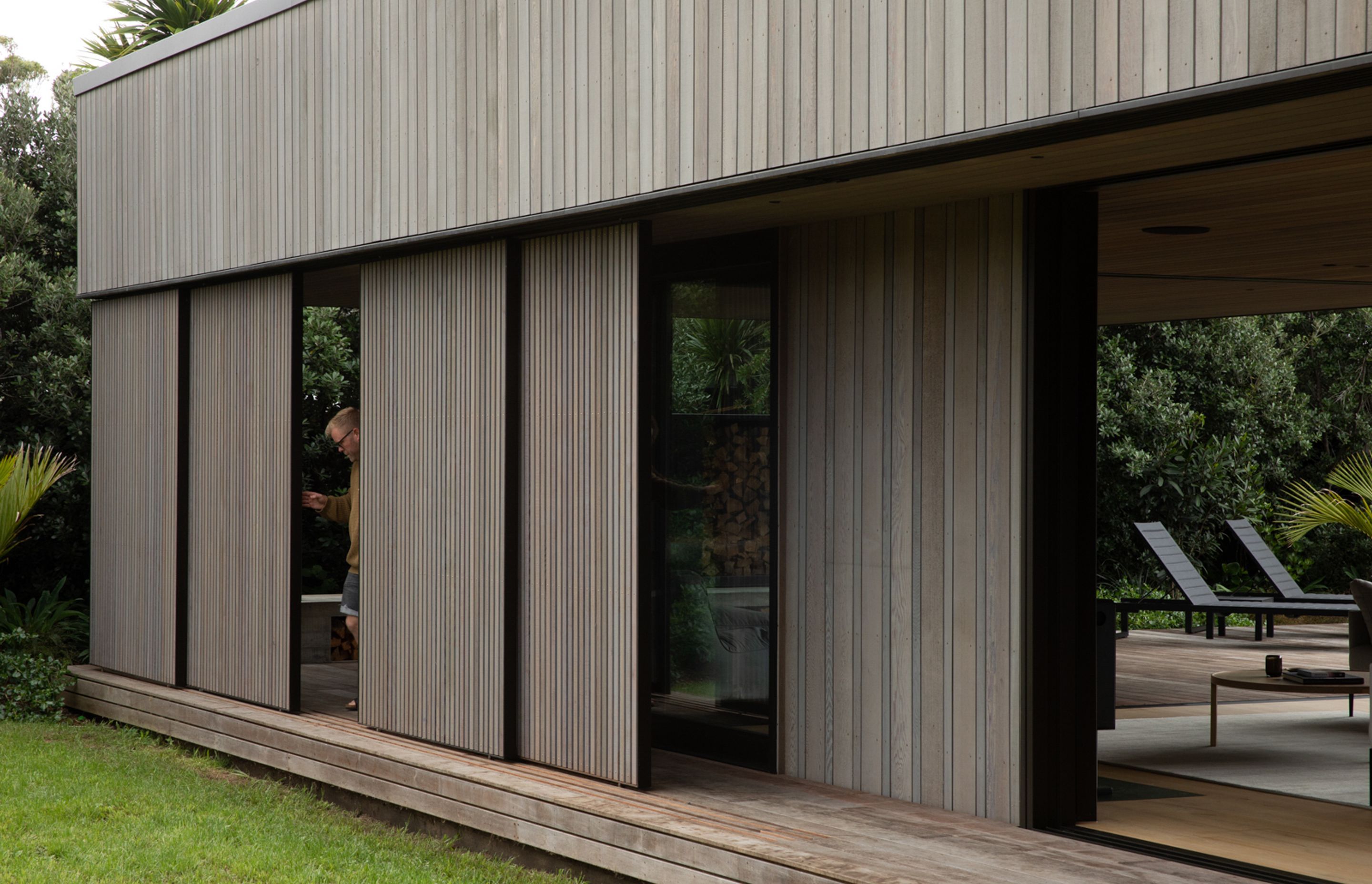 Cedar screens can be moved to screen the outdoor living space from rain, sun and wind. Image credit: David Straight