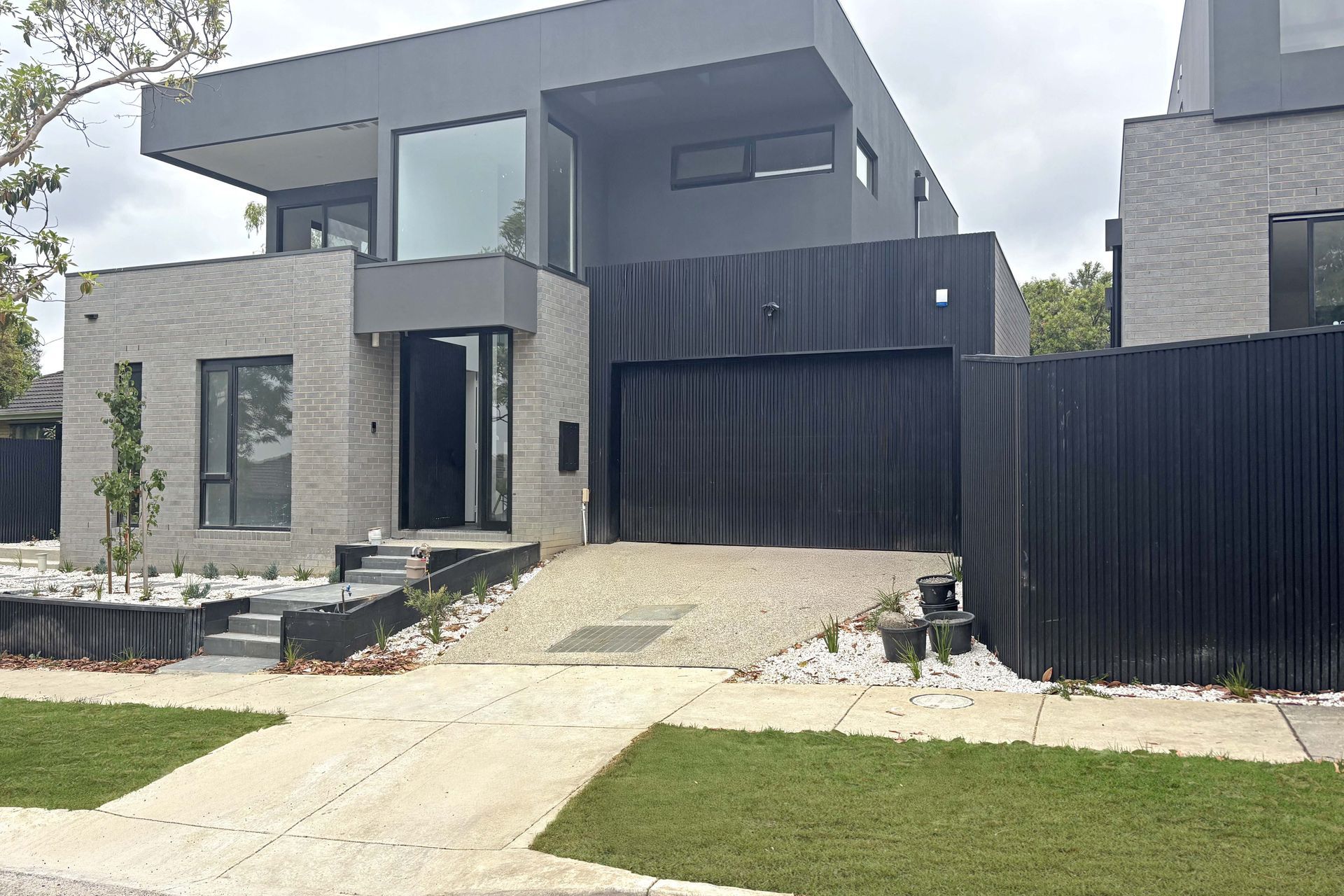 Real Timber Garage Door in Danmar Vertipanel design painted black
