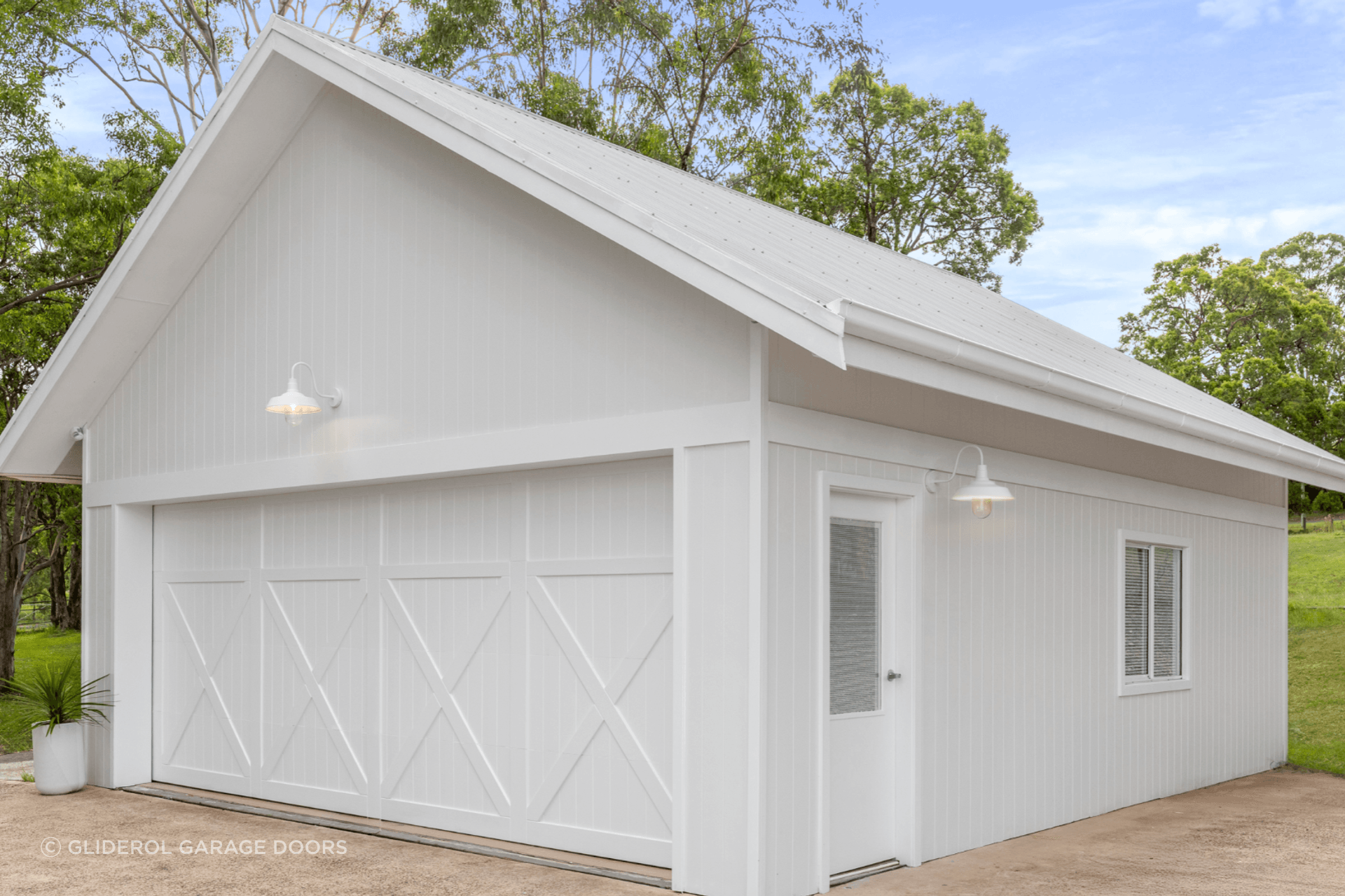 Real Timber Garage Door in Danmar Carriage Panel design painted white