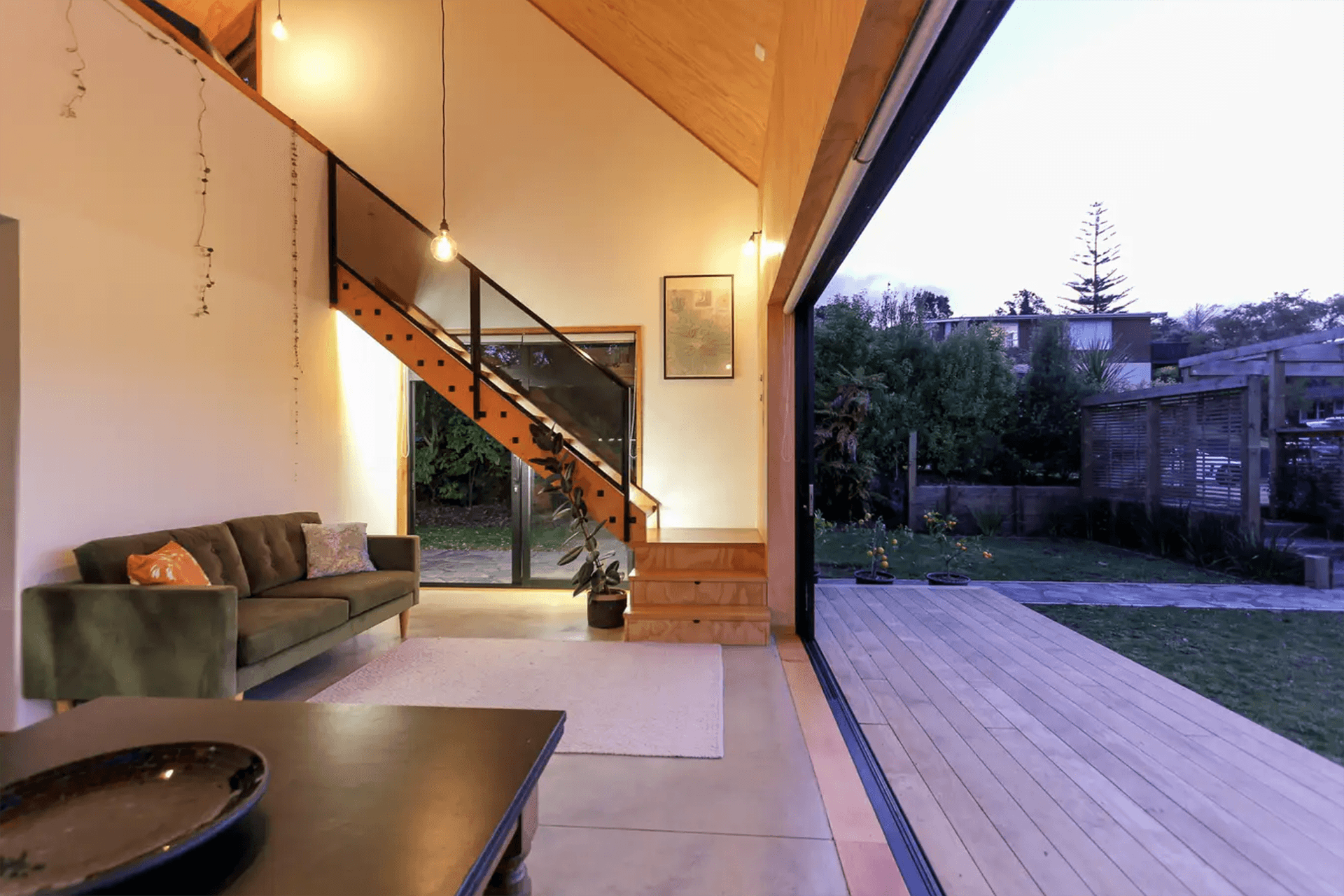 Sliding doors span almost the entire length of the ground floor living space, creating generous indoor-outdoor flow.