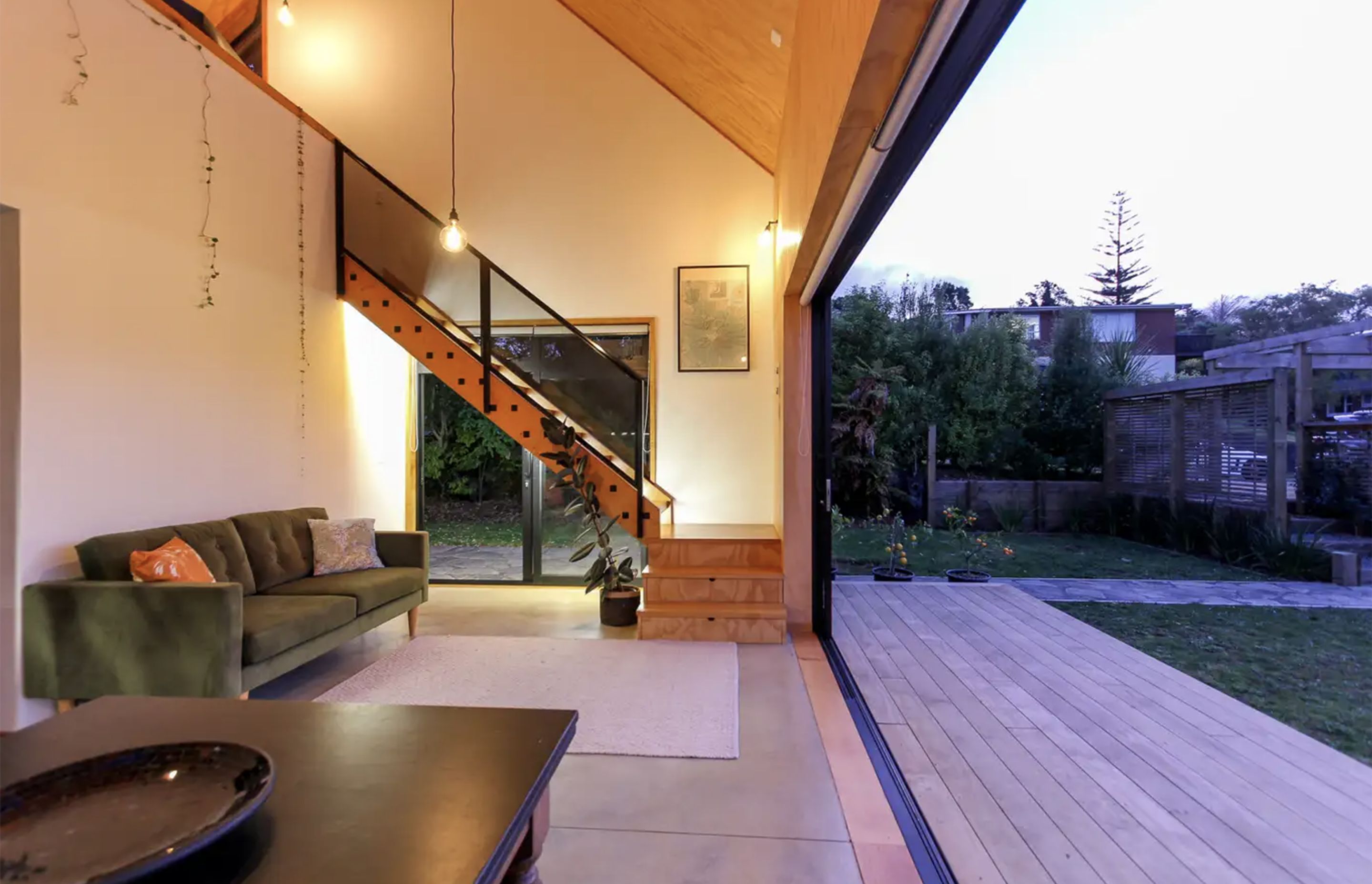 Sliding doors span almost the entire length of the ground floor living space, creating generous indoor-outdoor flow.