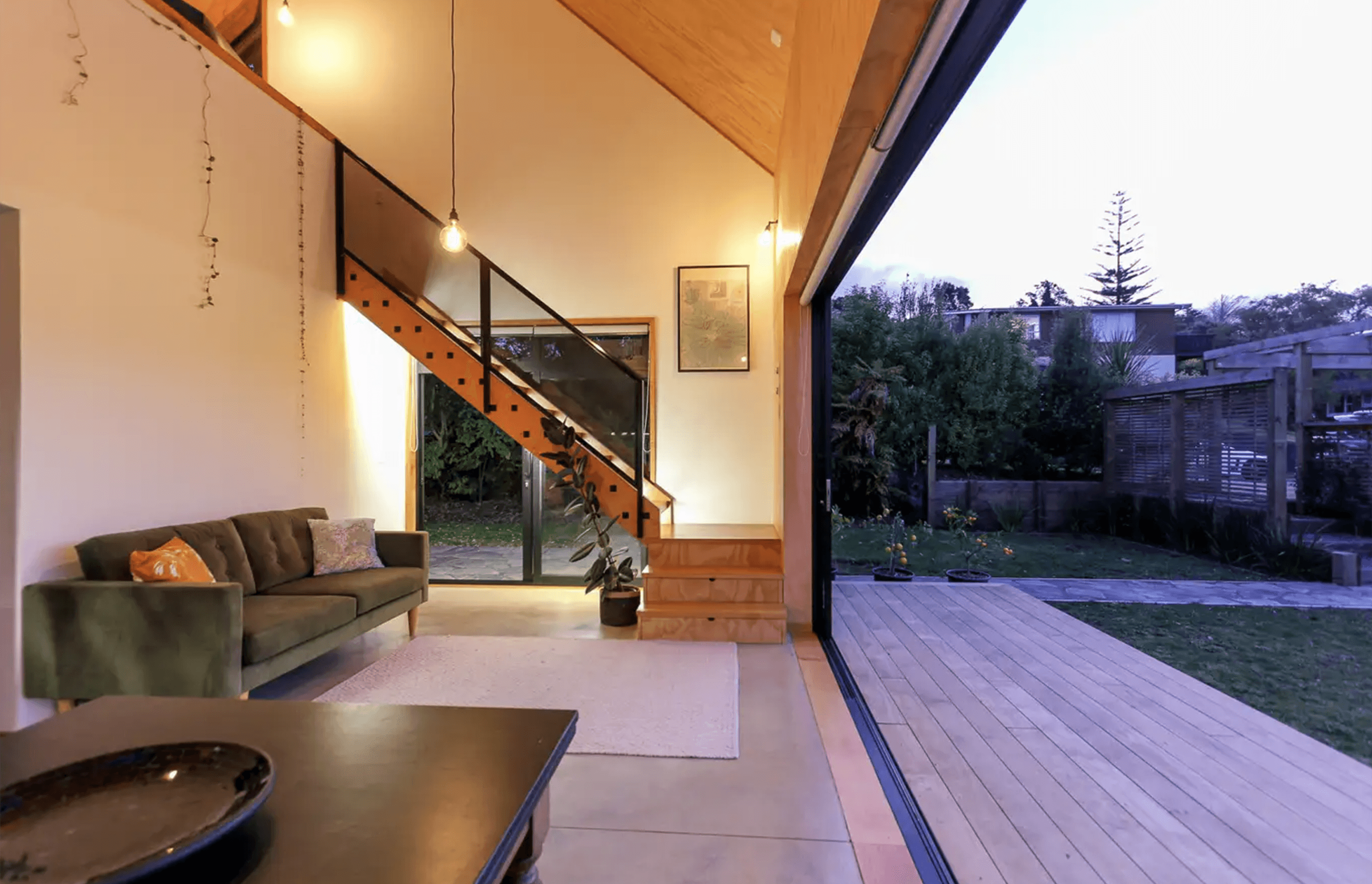 Sliding doors span almost the entire length of the ground floor living space, creating generous indoor-outdoor flow.