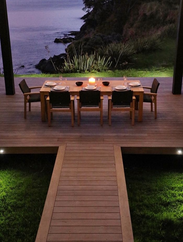 Entry to the site is down to the central outdoor dining space, under the louvred roof.