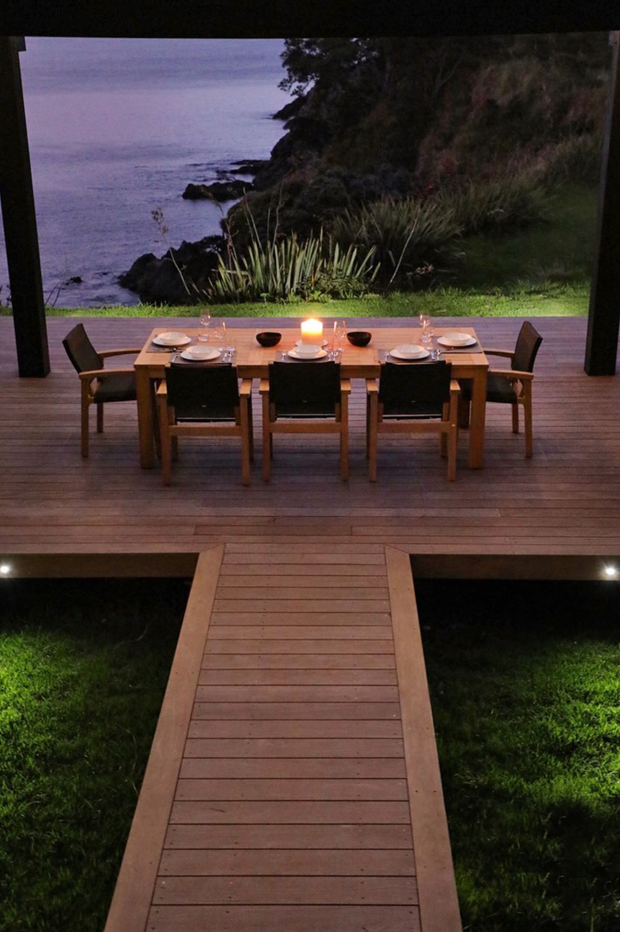 Entry to the site is down to the central outdoor dining space, under the louvred roof.