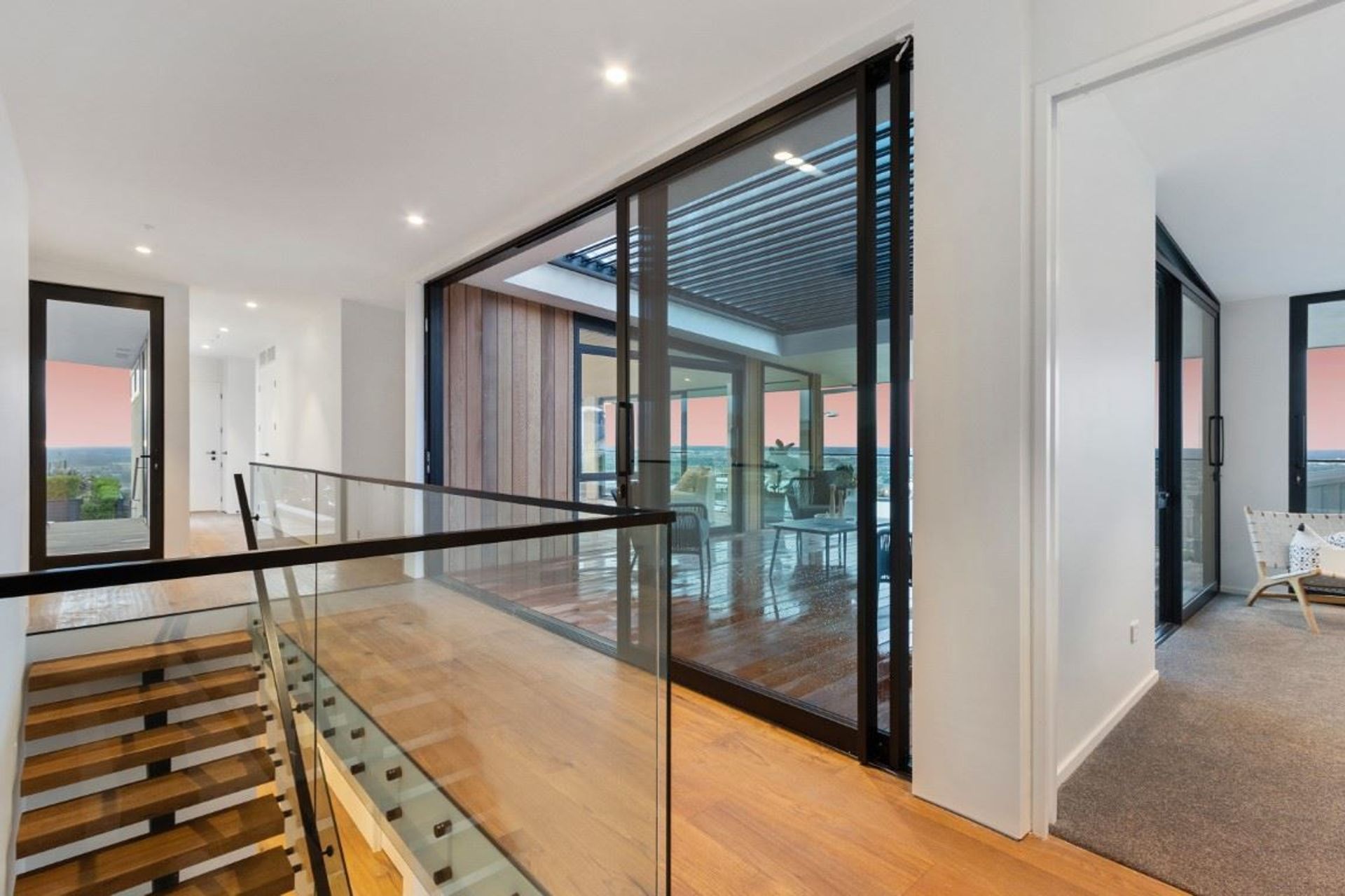 The frameless glass balustrade on this staircase helps the space feel bright and open.