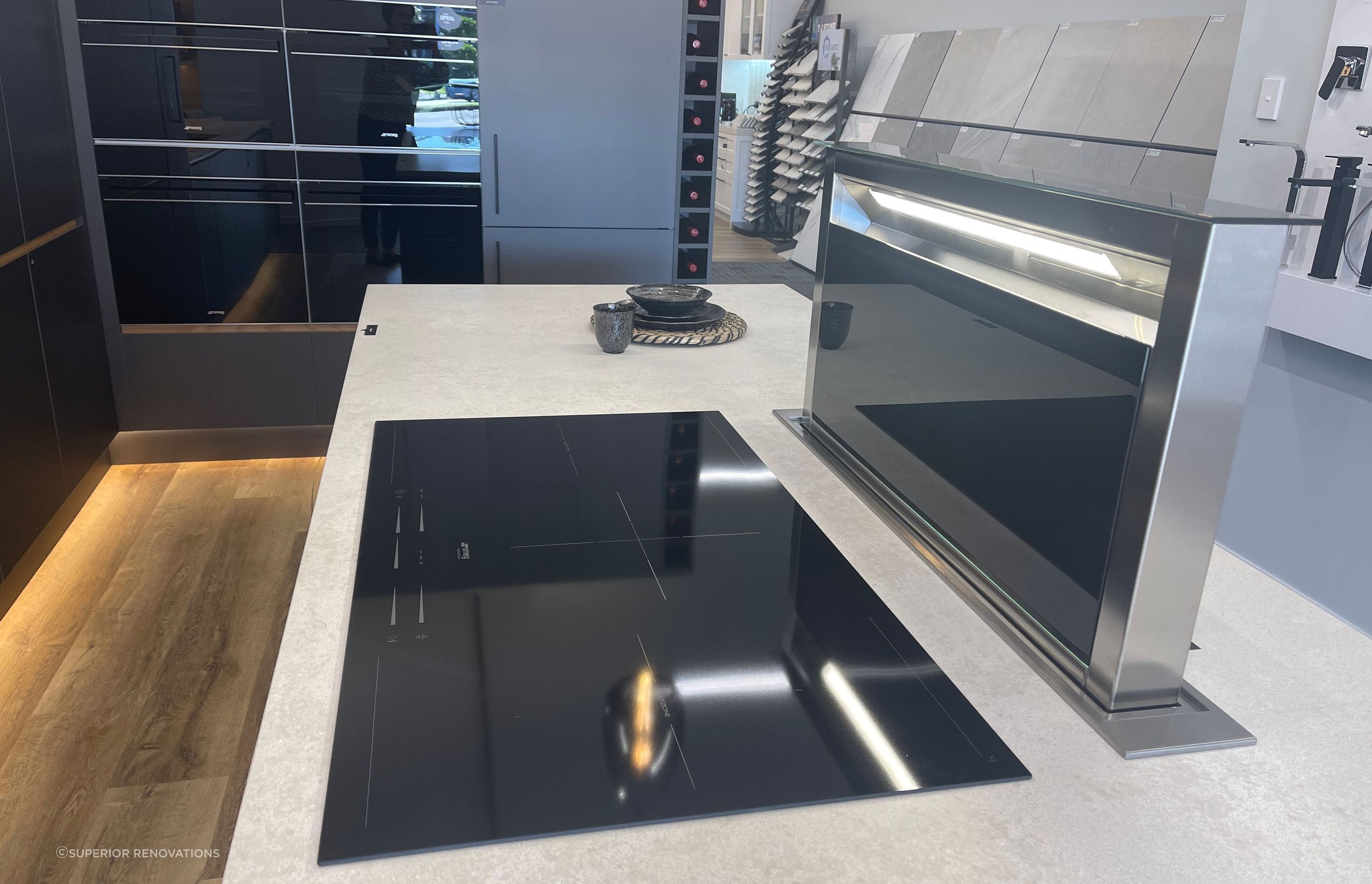 When in use the downdraft range hood comes up from the benchtop. This can be seen in our kitchen showroom in Auckland (Wairau Valley).