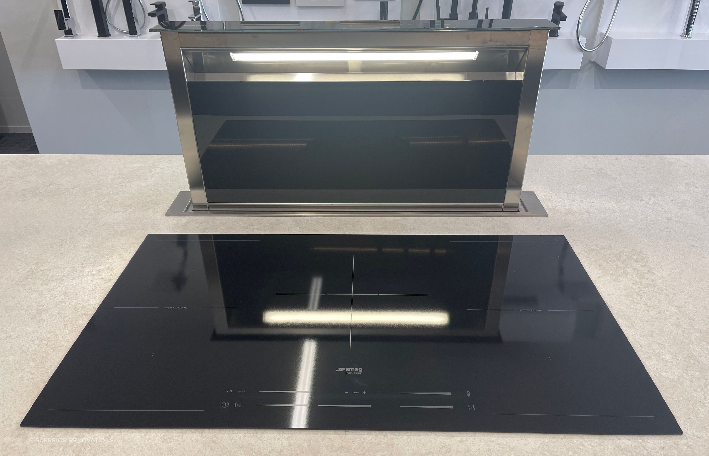 When you need to use the downdraft range hood, you simply press a button and it comes up.