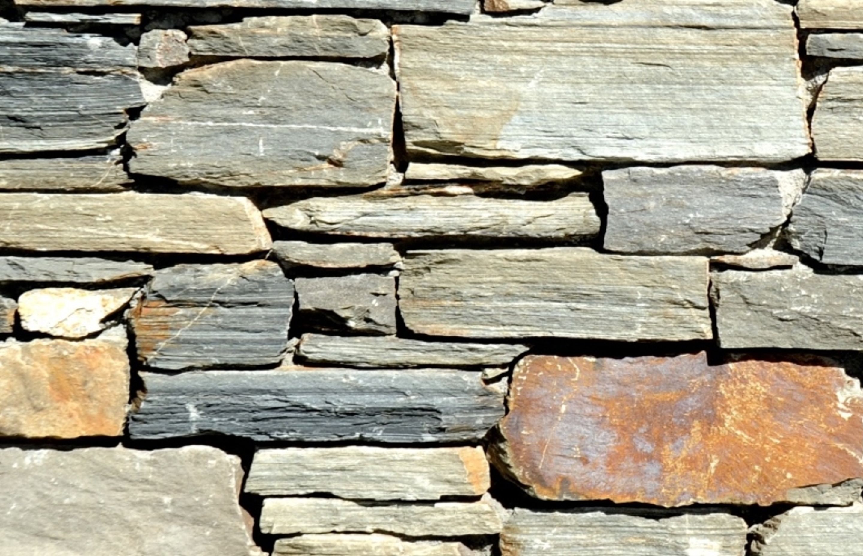 Dry Stacked (Tight Stacked): Stone is tightly stacked with no grout visible. This is a very popular style that harks back to ancient dry stone walls and showcases the stone. Genuine dry stacked walls contain no grout at all, however this is not possible