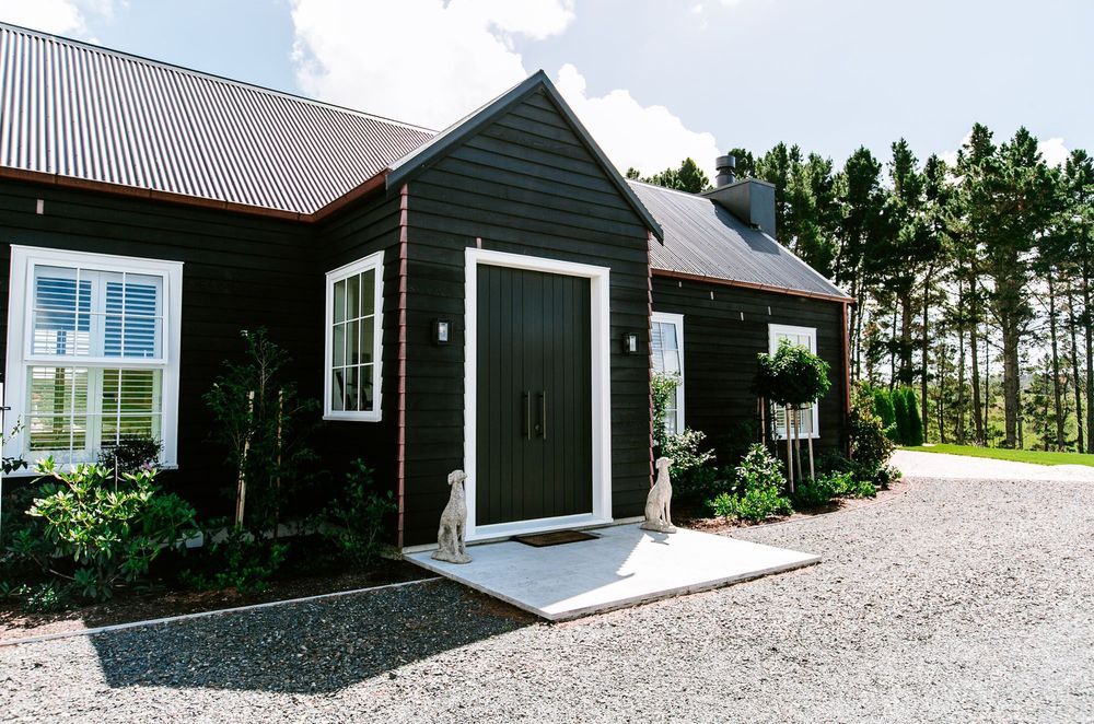 A bold white against black frame makes for a strong entrance to this exquisite Duck Creek home