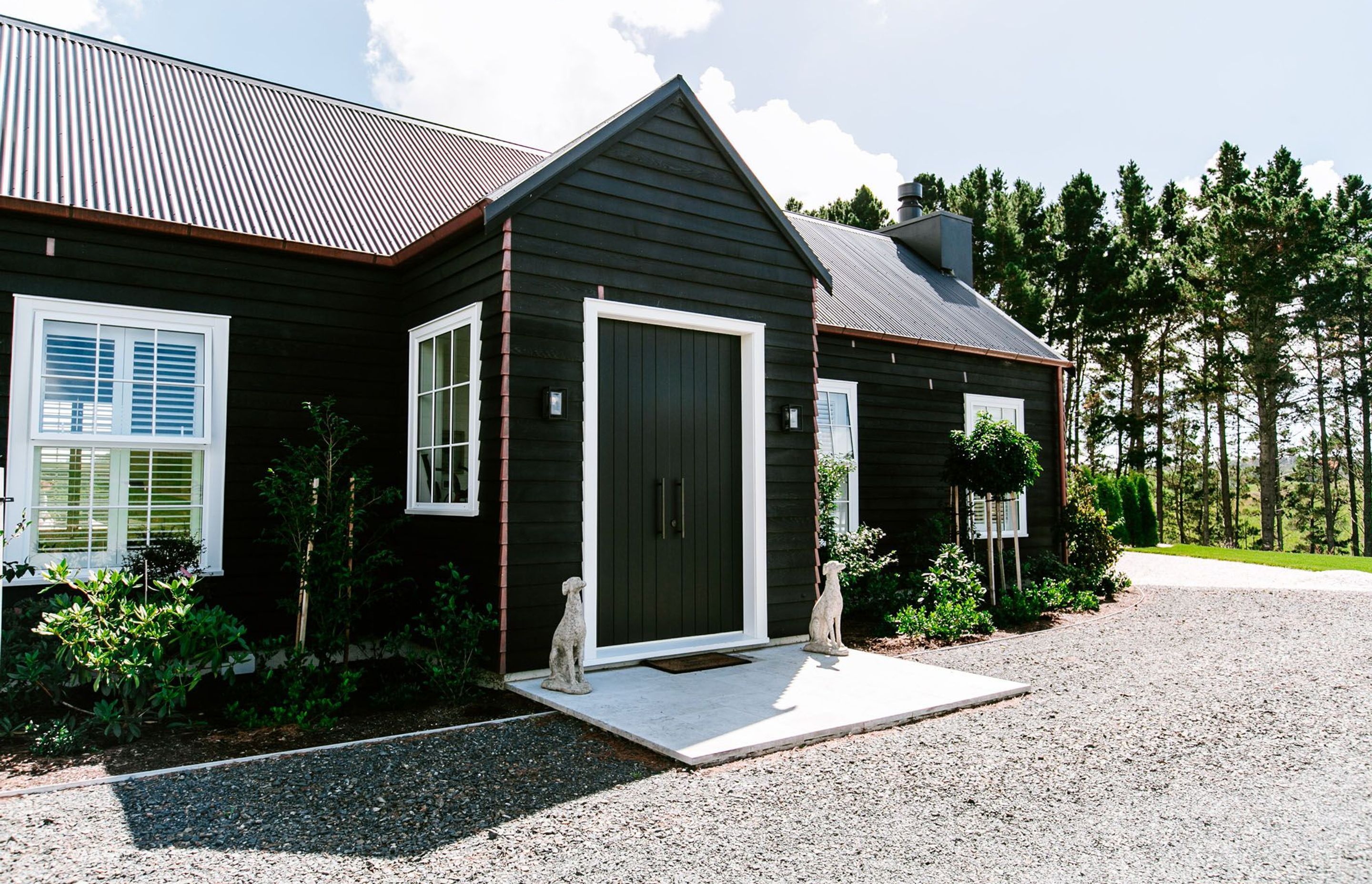 A bold white against black frame makes for a strong entrance to this exquisite Duck Creek home