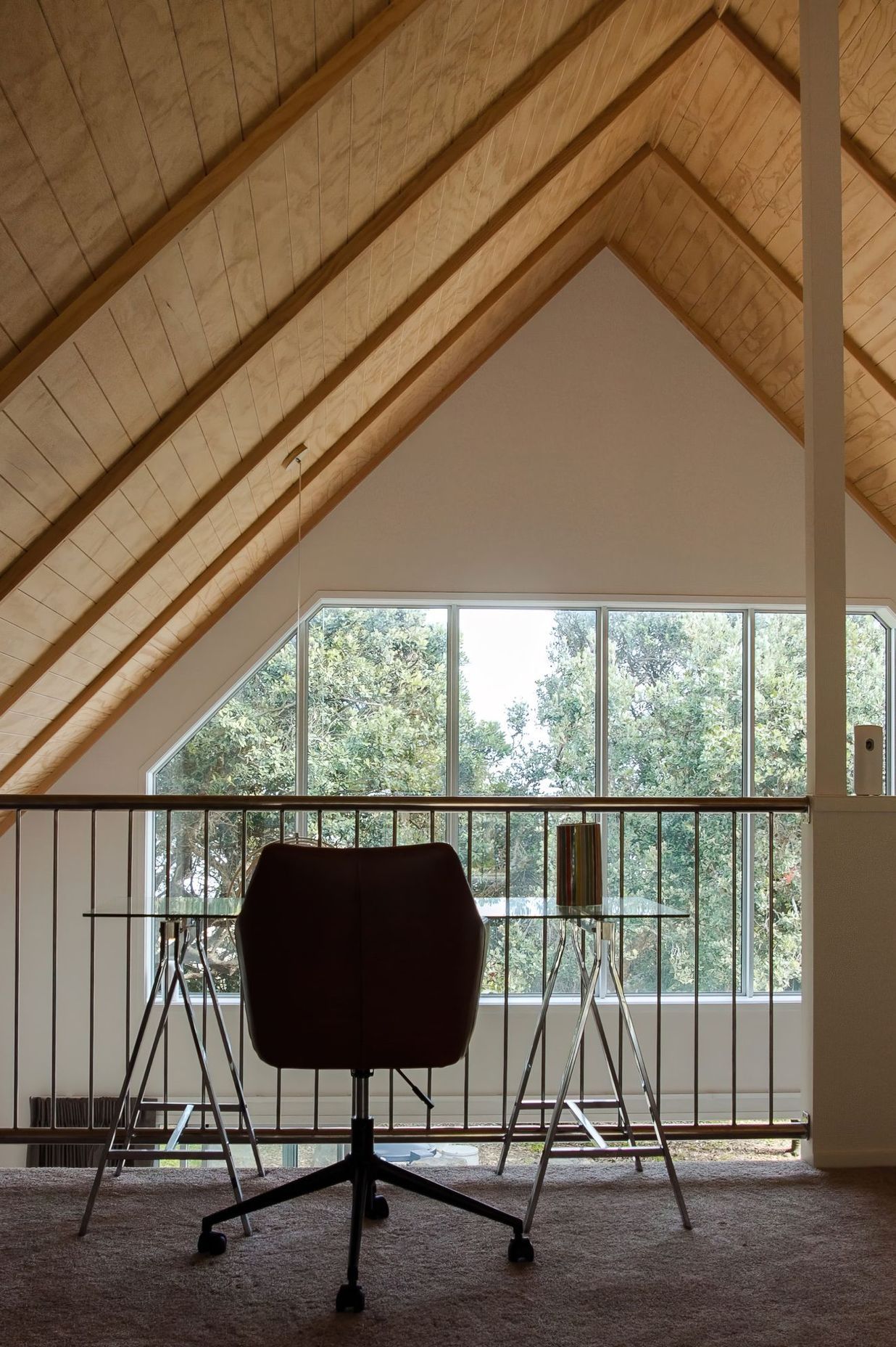 The exposed timber ceiling brings an alpine cabin feel to this Baylys Beach getaway.