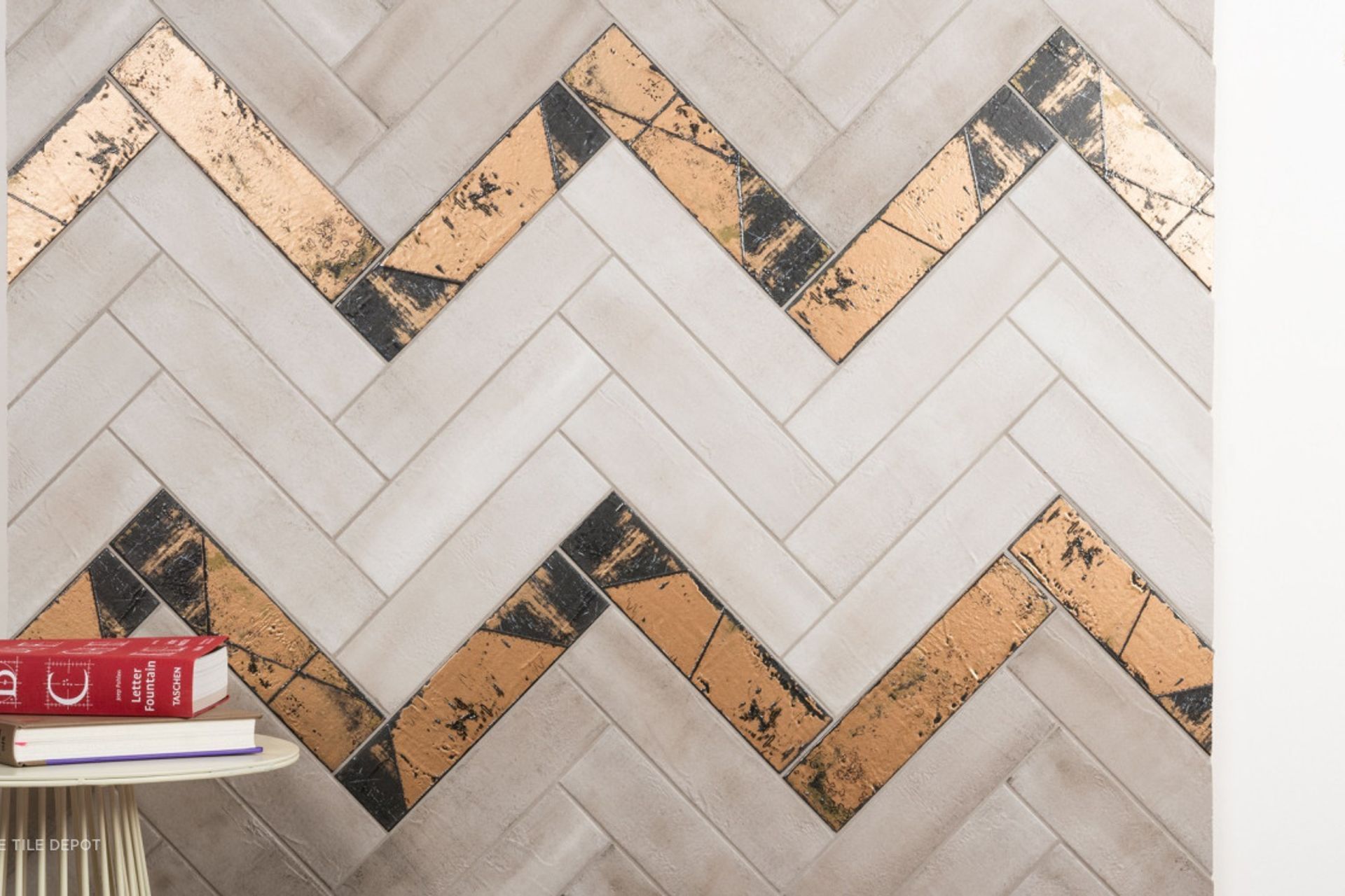 These tiles are a great example of mixing neutral coloured tiles with a more bold tile to create interest within a feature wall without covering the entire wall with a bold colour (Tile Depot, 2021)