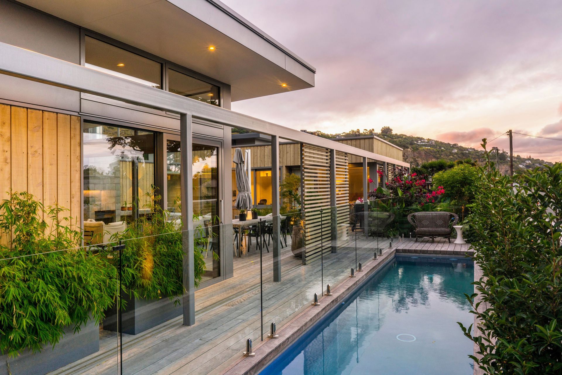 Generous roof overhangs, an extensive colonnade accommodating timber sliding screens and a central courtyard with outdoor fi re blur the boundary between house and landscape