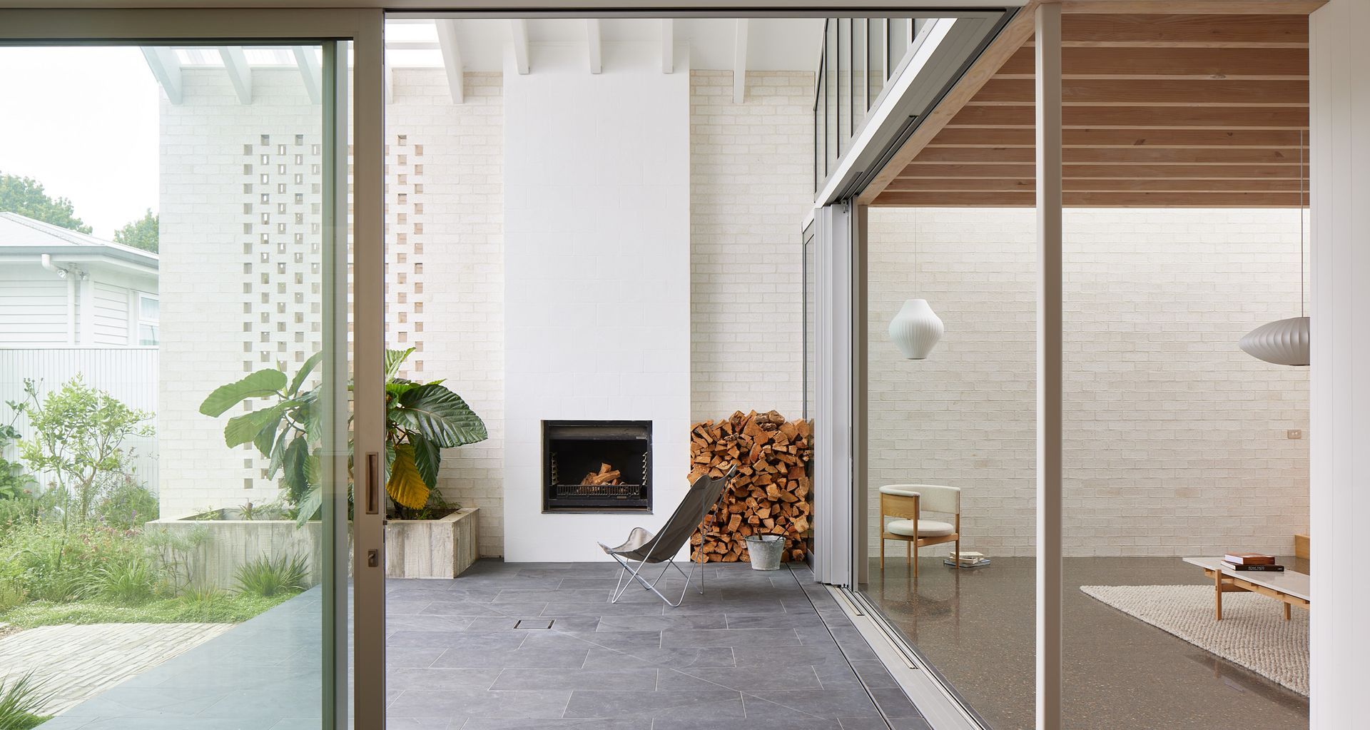 Point House by Guy Tarrant Architects with furniture from Good Form – N-CC01 Lounge Chair and N-CT01 Coffee Table by Karimoku Case. Photography by Simon Wilson