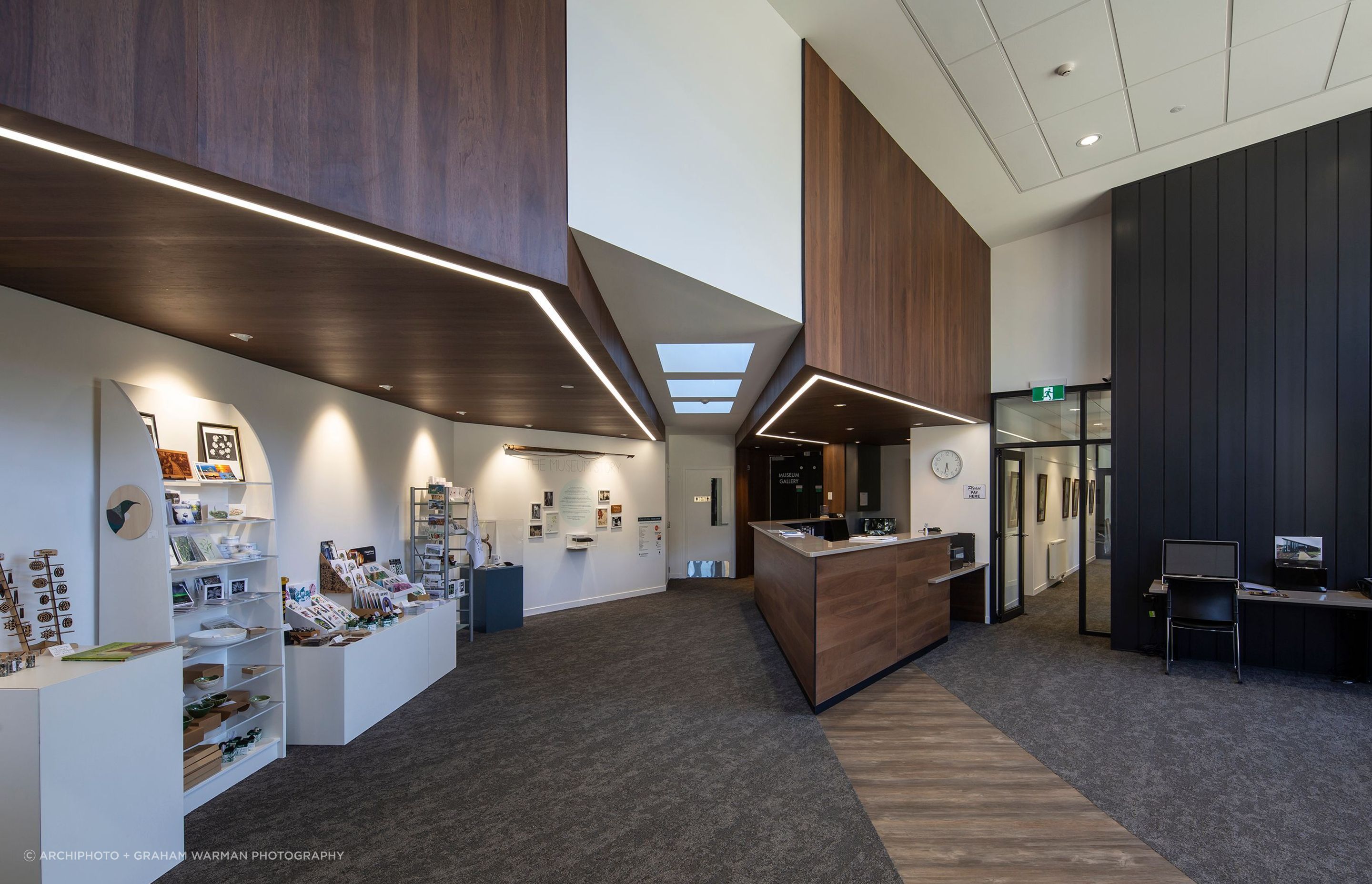 The entry foyer is filled with light; the corridor to the right of the reception desk leads to the offices and cafeteria, while to the left are the museum galleries.