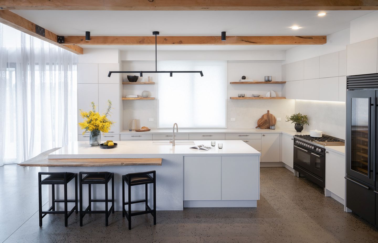 Image by: Freedom Kitchens, White transparent drapes over the windows brighten up the kitchen