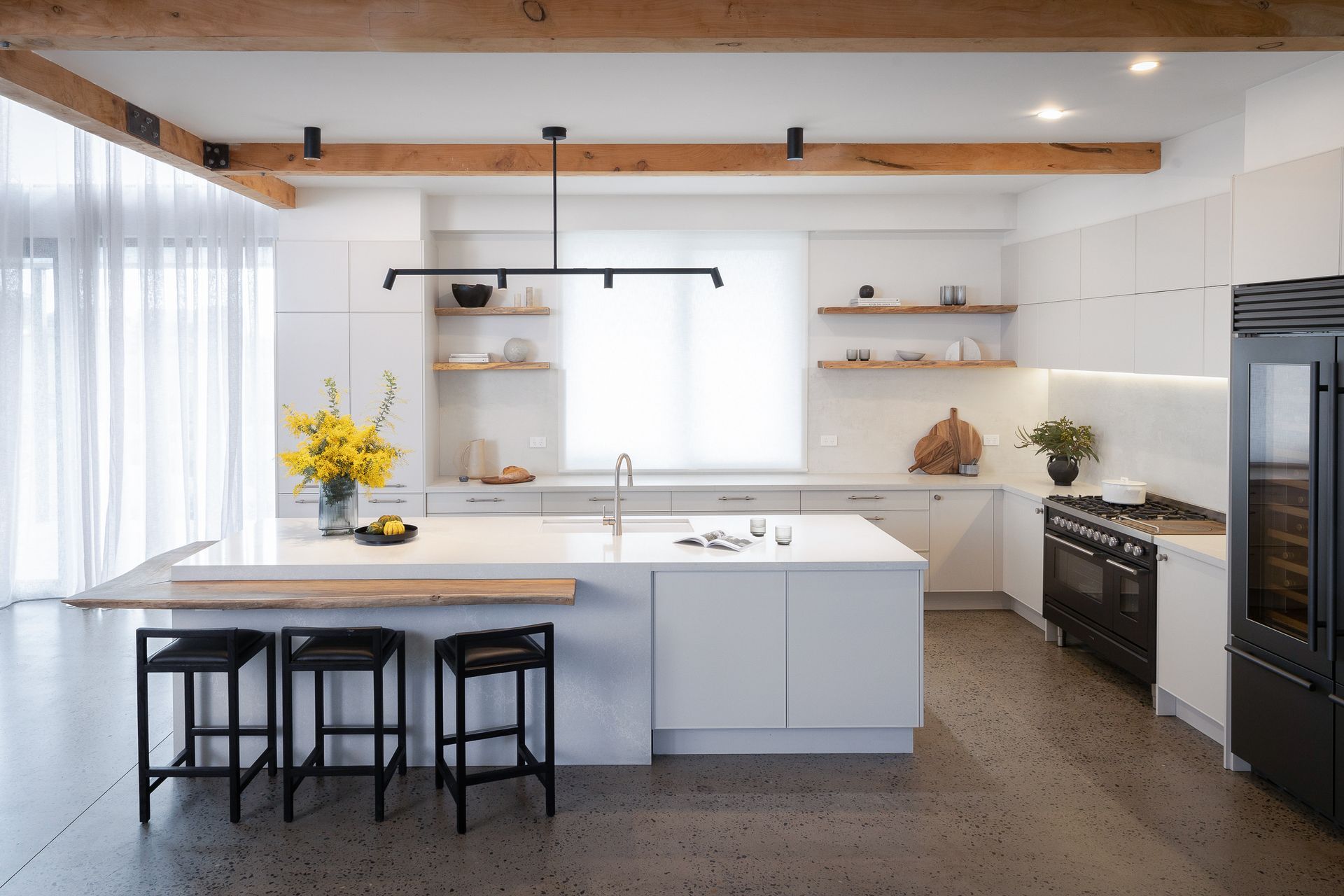 Image by: Freedom Kitchens, White transparent drapes over the windows brighten up the kitchen