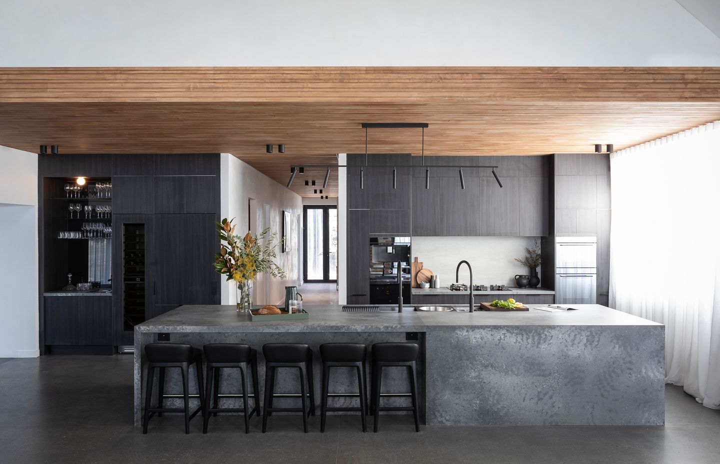 Image by: Freedom Kitchens, The stone benchtop and grey timbers encompassing dark tones