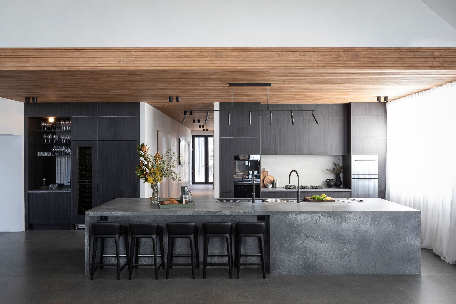Image by: Freedom Kitchens, The stone benchtop and grey timbers encompassing dark tones