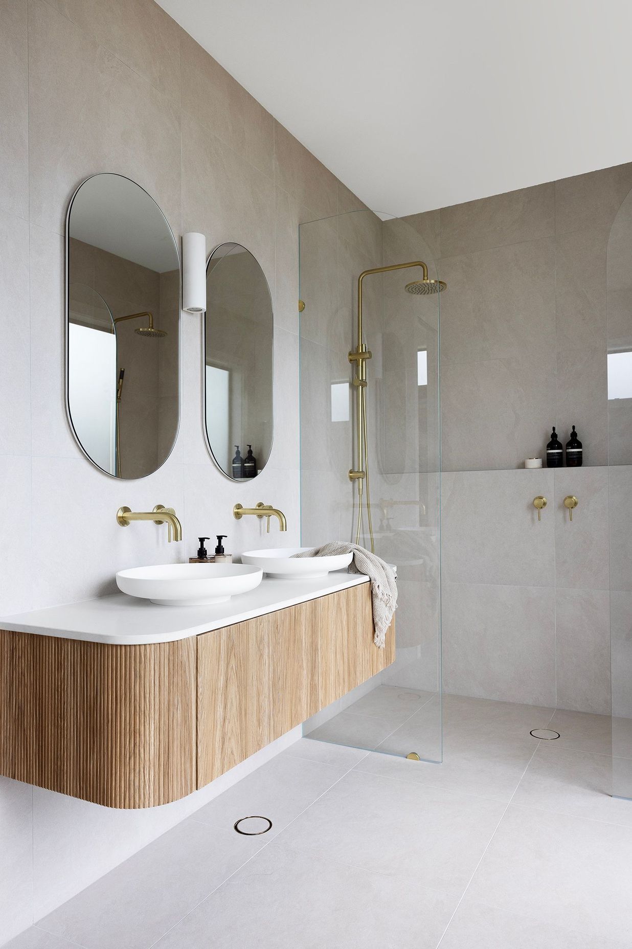 The ensuite features an ADP Bloom wall mixer in brushed brass and ADP Bloom wall spout in brushed brass.