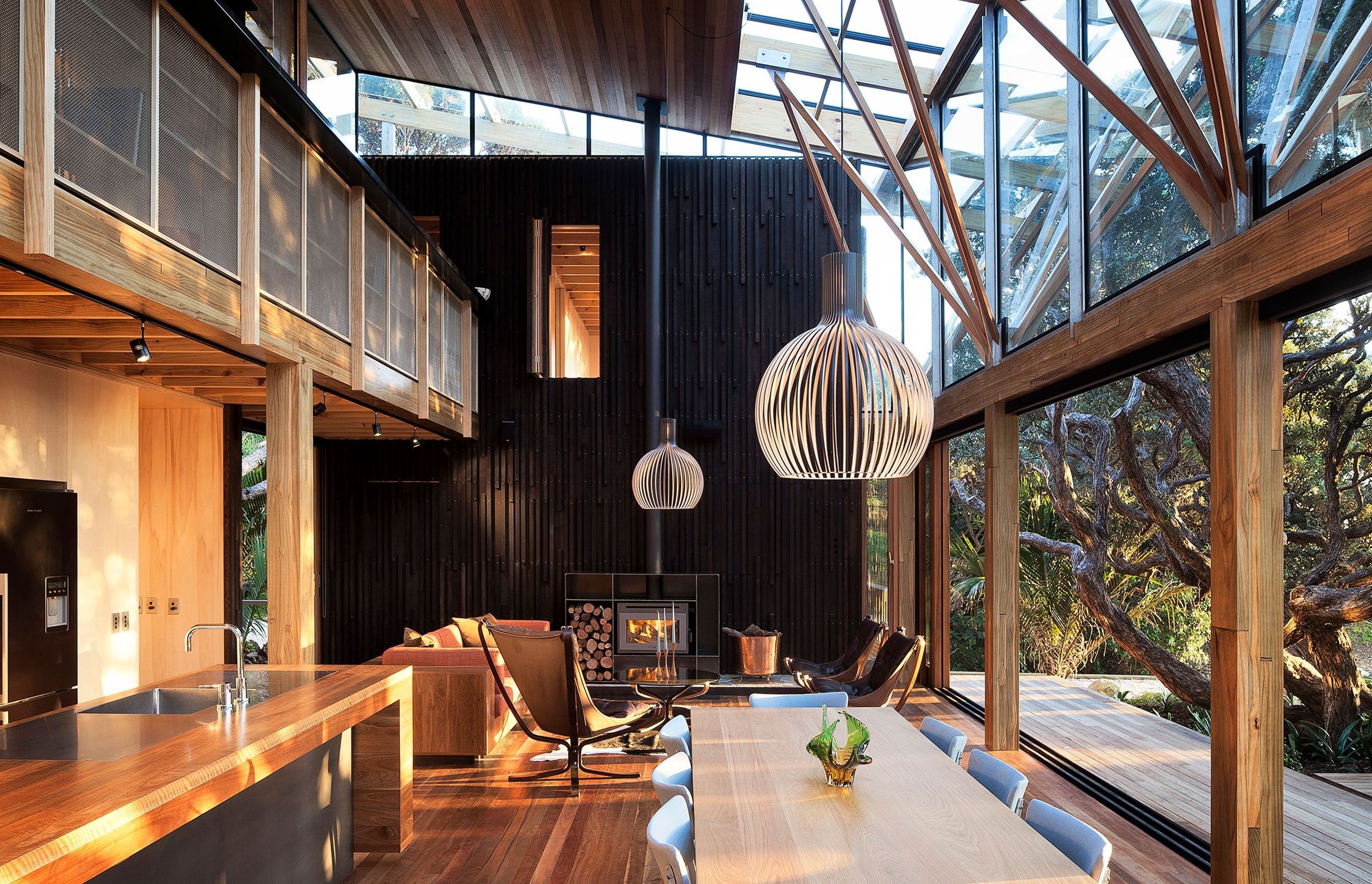 Herbst Architects’ Under Pohutukawa house (above and in the top banner image) is part of its setting through the layering and expression of timbers, structure and space. Photograph by Patrick Reynolds.