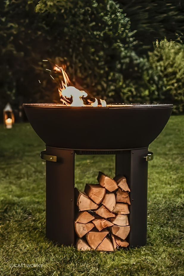 The Hergóm Zenith Cast Iron Fire Pit contains functional storage for firewood.