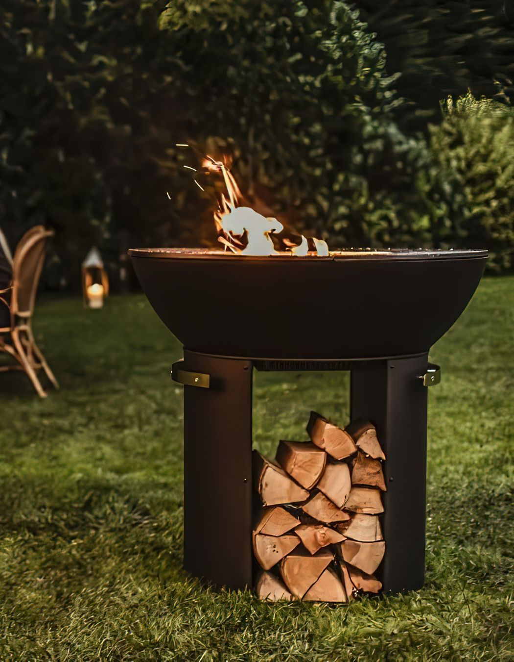 The Hergóm Zenith Cast Iron Fire Pit contains functional storage for firewood.