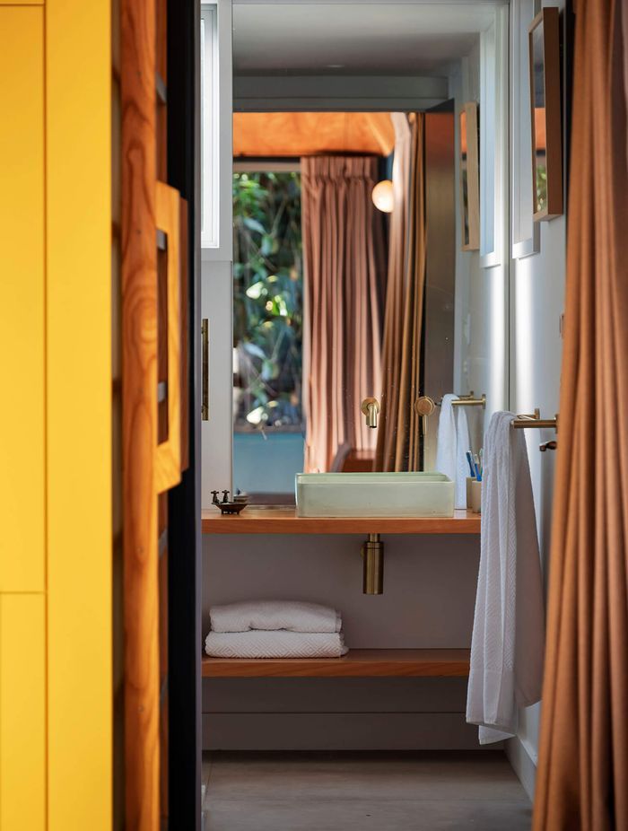 The bathroom is neatly tucked below the mezzanine.