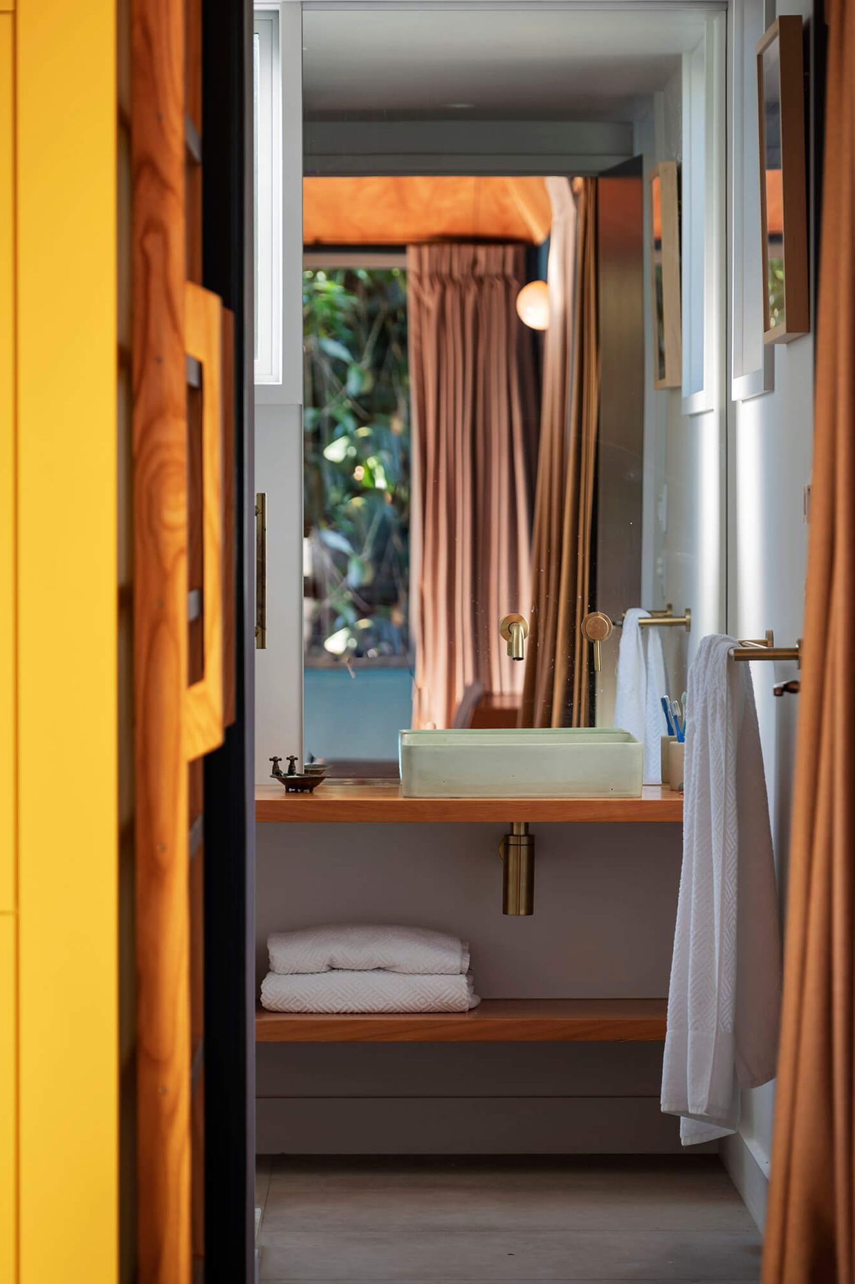 The bathroom is neatly tucked below the mezzanine.