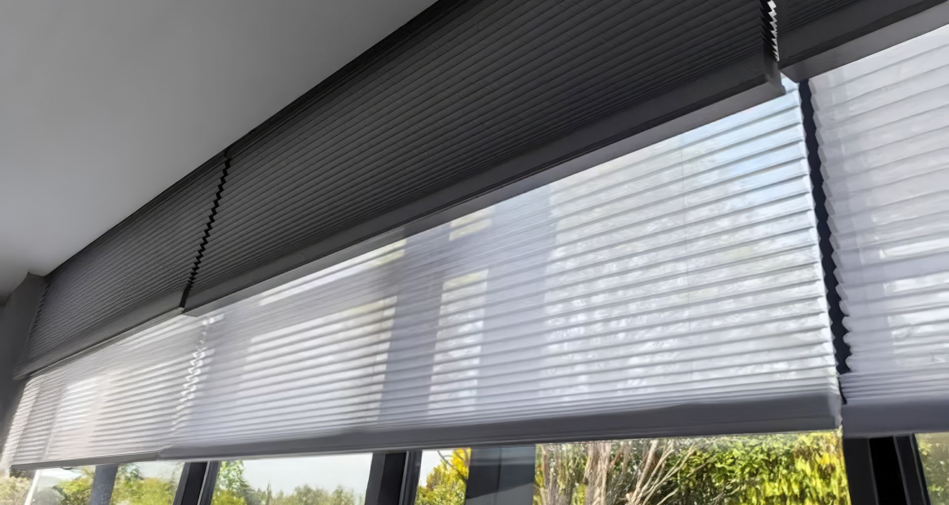 A dual “Day Night” Honeycomb system that combines blackout and light-filtering fabrics within one blind.