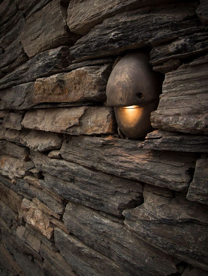 Subtle but attractive outdoor lighting by Lighting Revolution accents the stonework used on the Horseshoe Bend property.