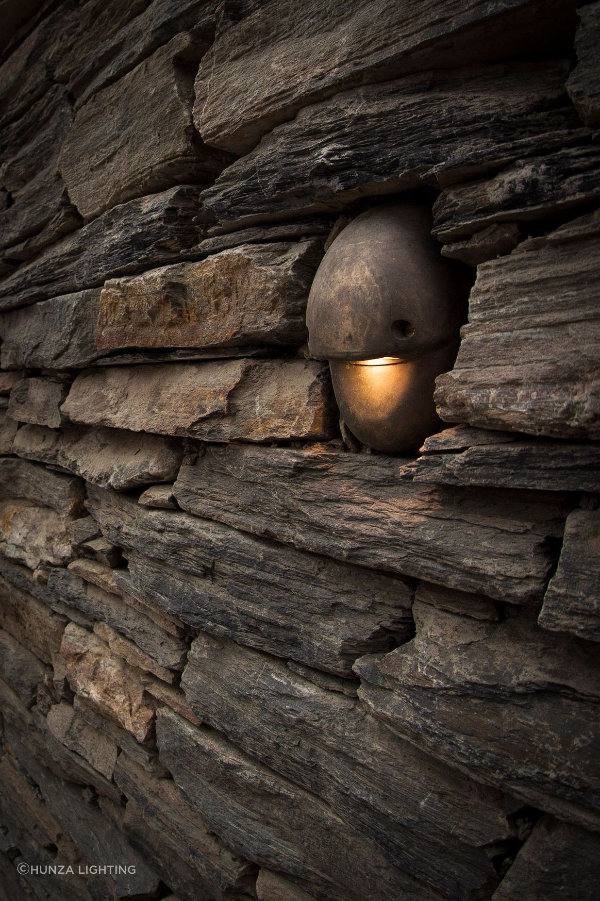 Subtle but attractive outdoor lighting by Lighting Revolution accents the stonework used on the Horseshoe Bend property.