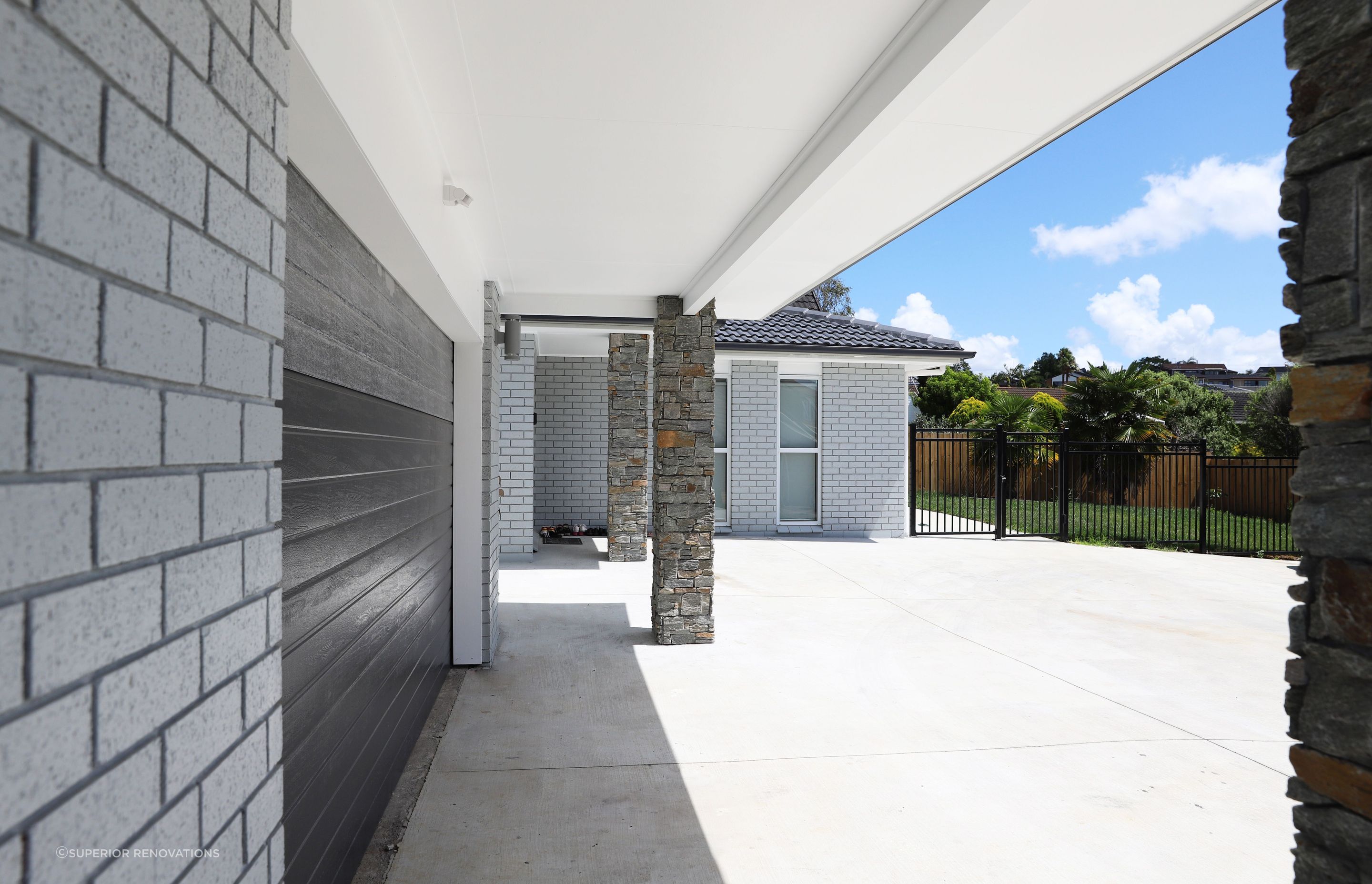 Concrete Driveway and a fenced side garden in this landscaping project in West Harbour, Auckland
