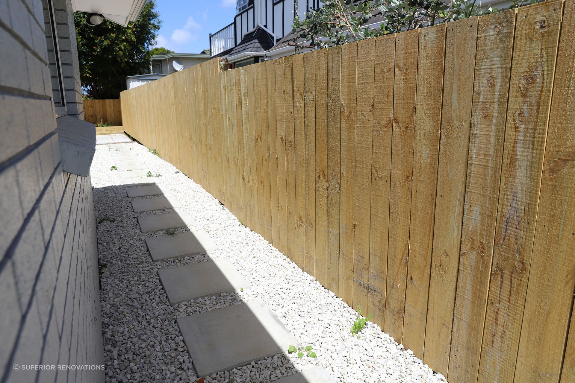 We created pathways around the house to get from one section of the exterior to another. This pathway leads from the front garden to the back of the house where we created a vegetable garden and patio