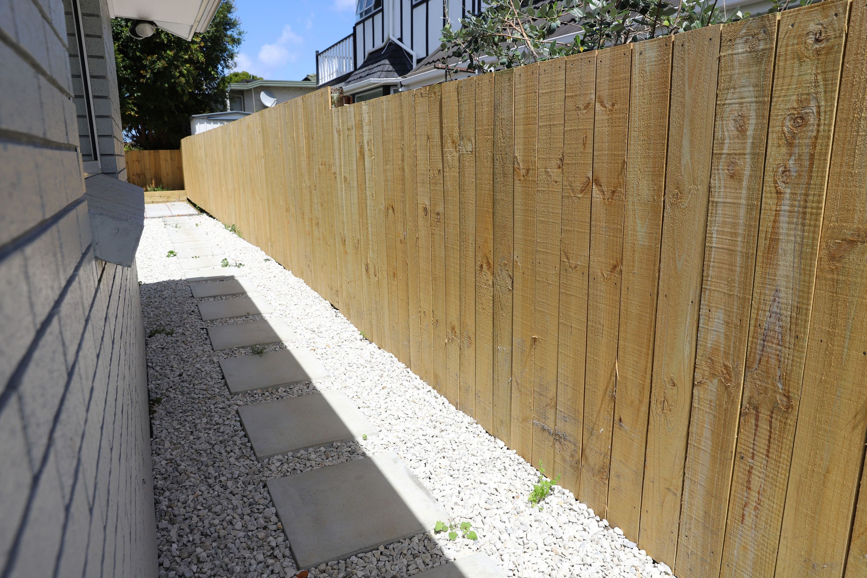 We created pathways around the house to get from one section of the exterior to another. This pathway leads from the front garden to the back of the house where we created a vegetable garden and patio