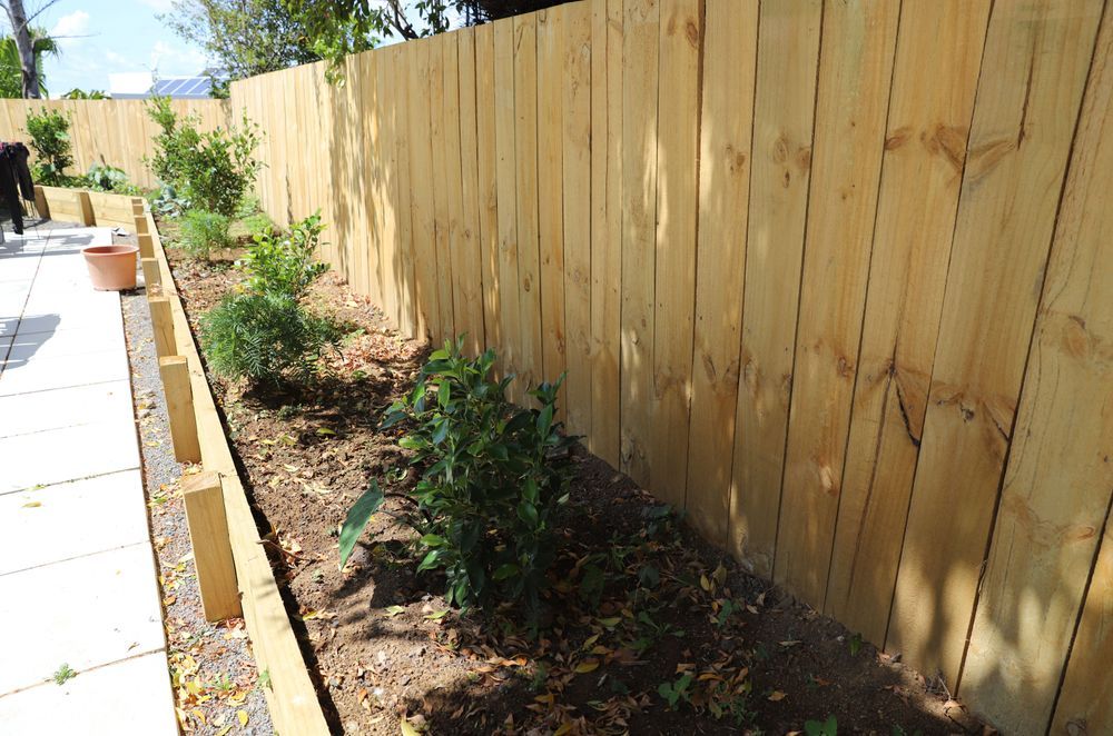 The vegetable garden surrounds the concrete patio with Timber fencing throughout.
