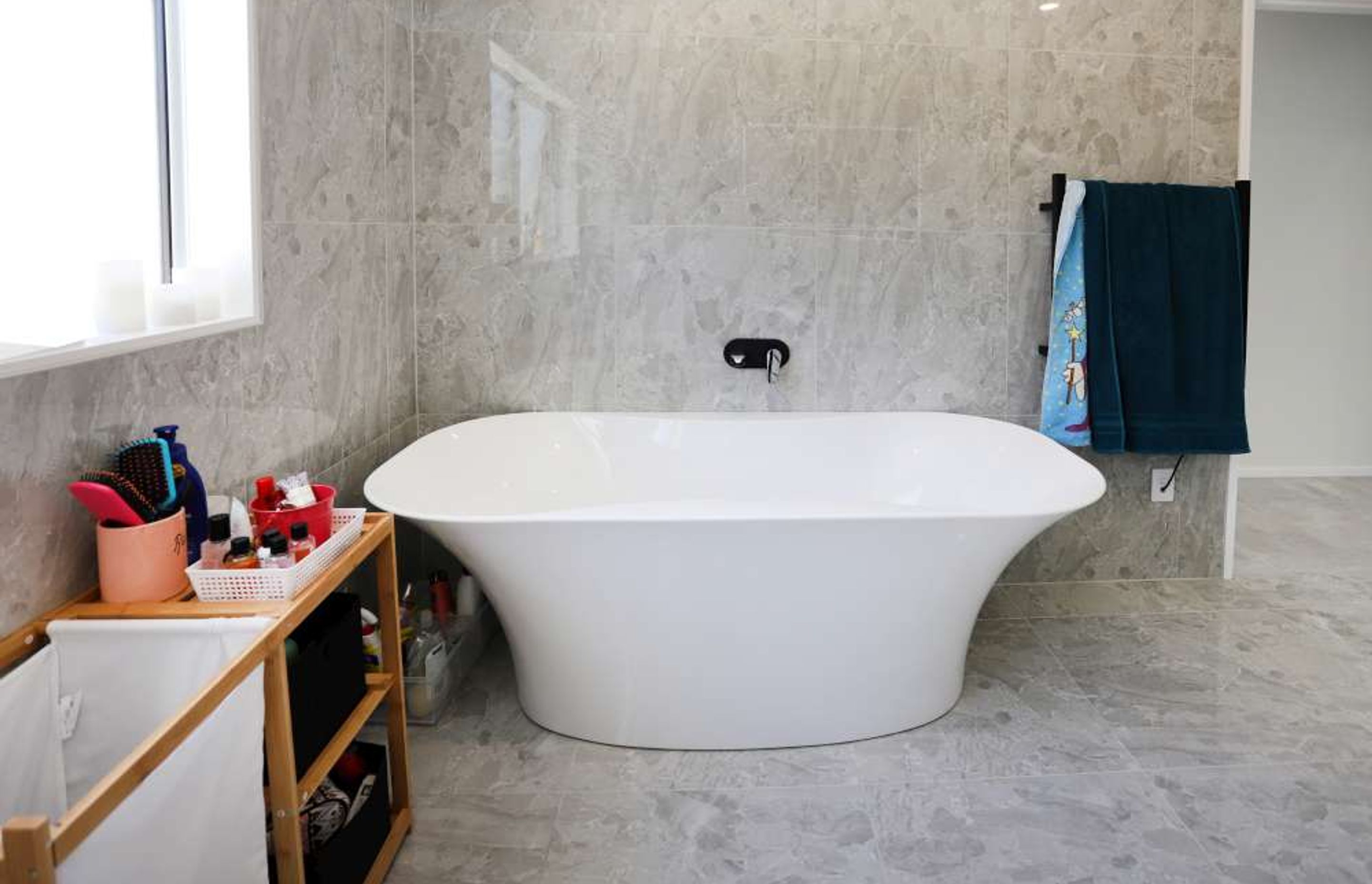 standing bathtub was incorporated in this ensuite in this bathroom renovation in West Harbour