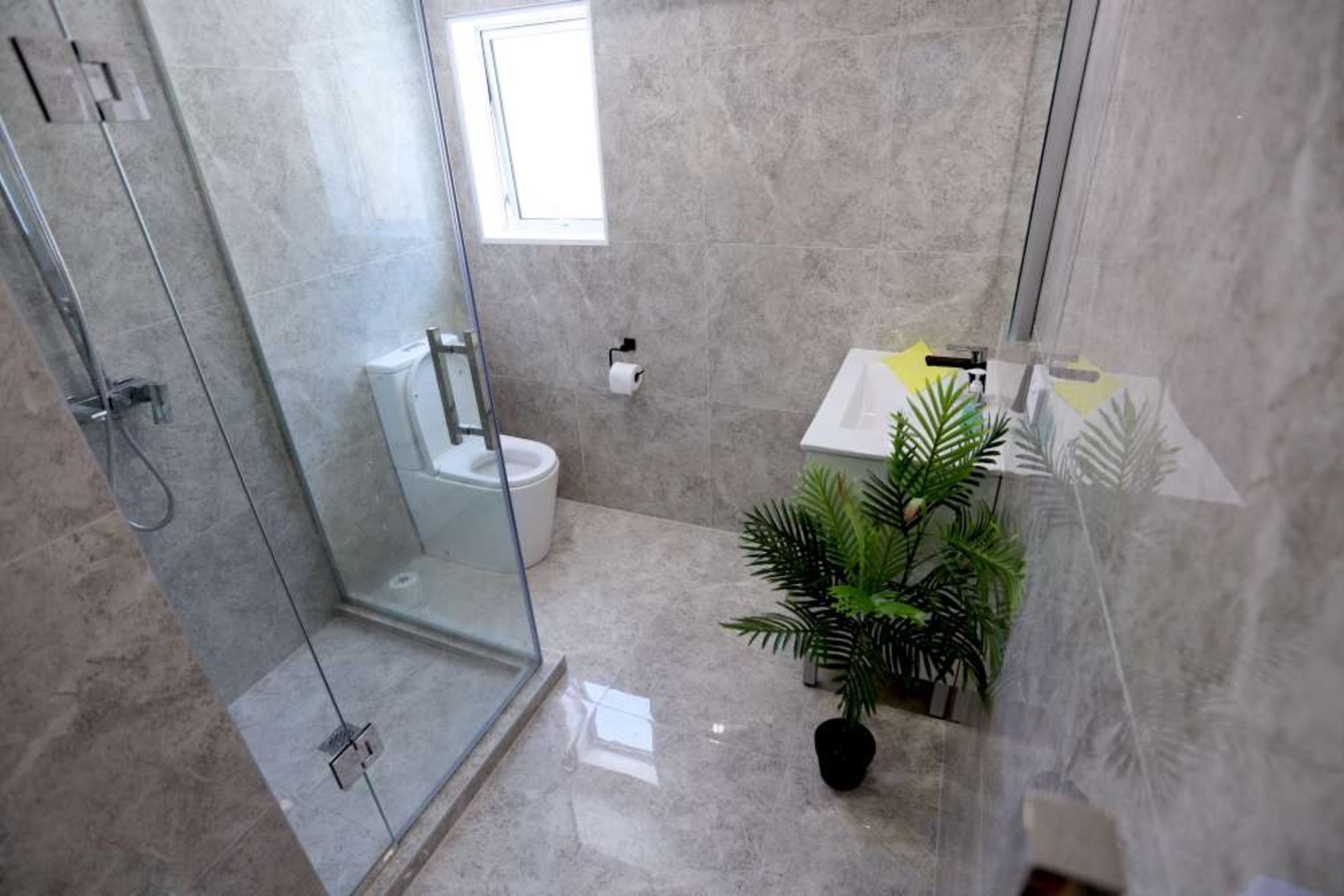 600 by 900 tiles used in this small bathroom