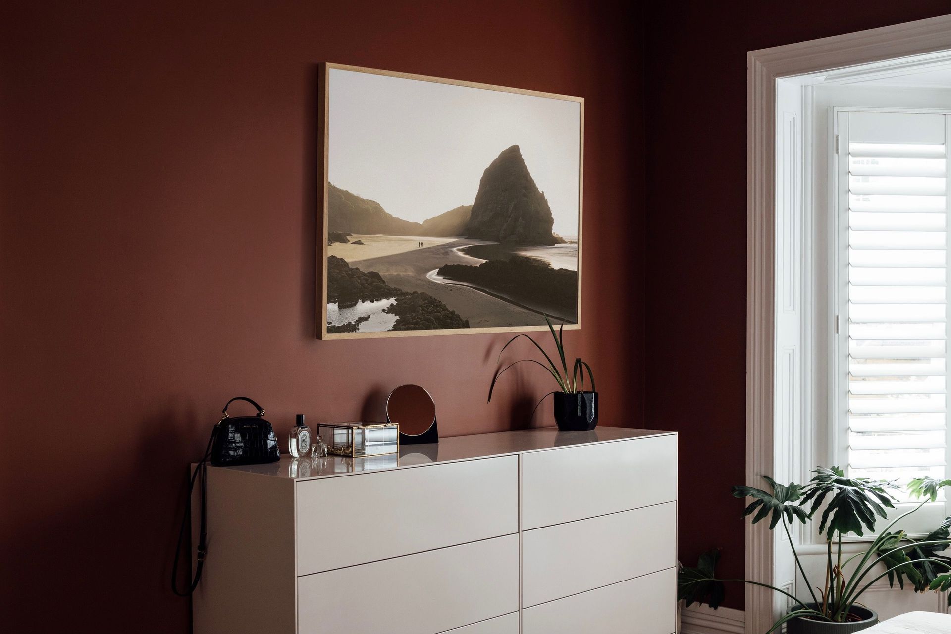 A respite from the trend of 'bright and white', homeowners are now adopting moody colours in the bedroom. Image: Duncan Innes.