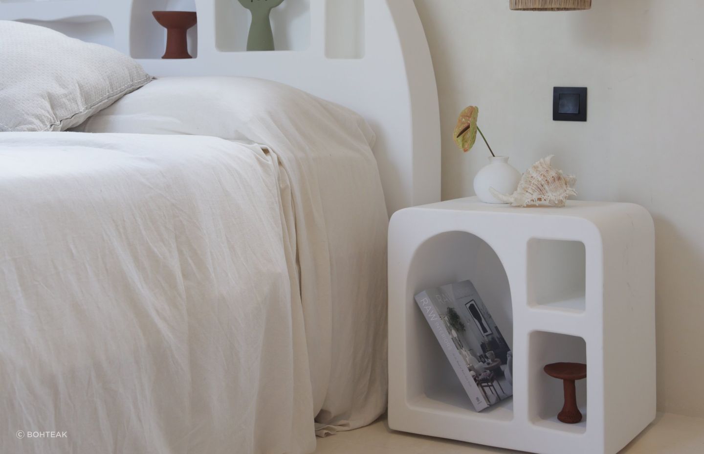 A minimalist bedroom with a clean interior design is a great setting for a Mediterranean bedside table. Featured product: Mykonos Side Table.