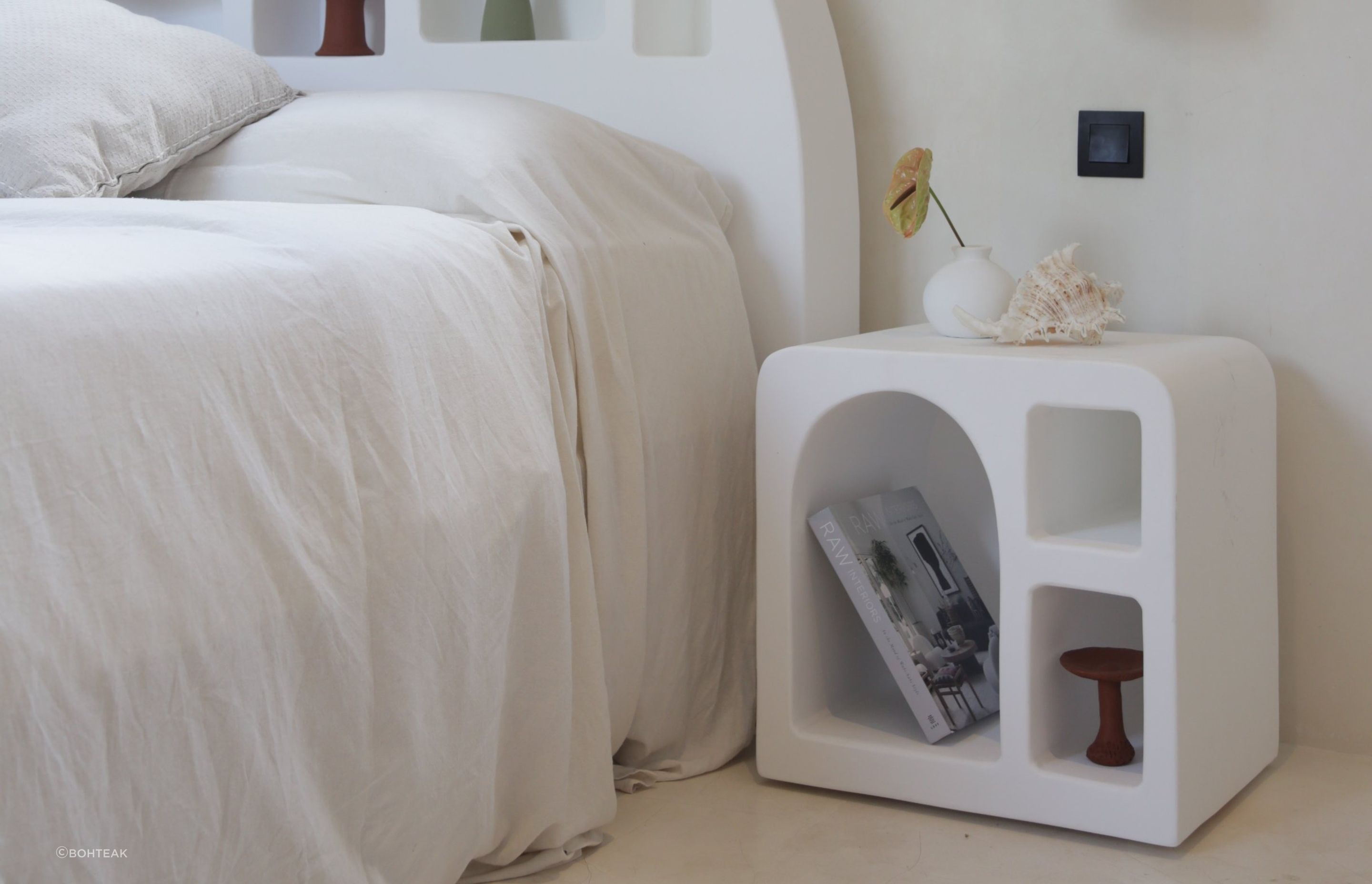 A minimalist bedroom with a clean interior design is a great setting for a Mediterranean bedside table. Featured product: Mykonos Side Table.