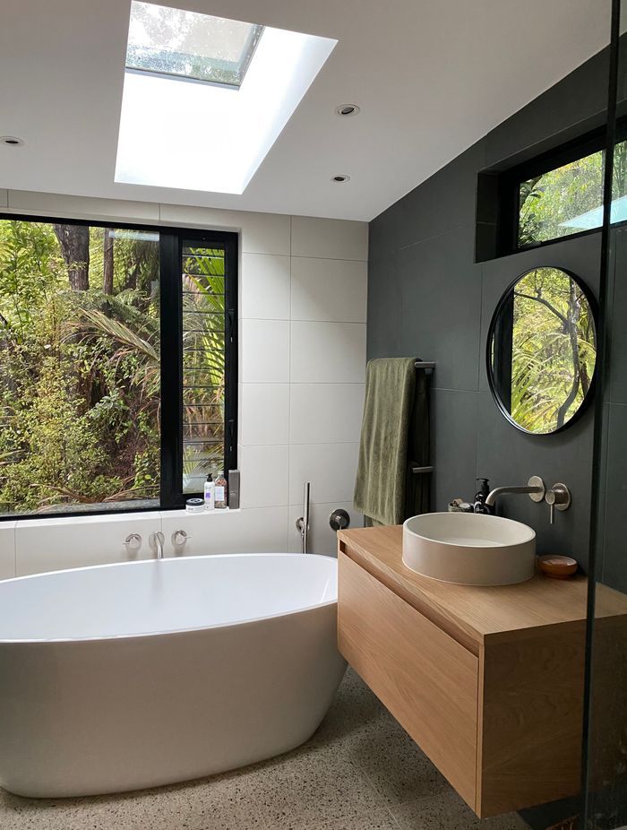 The floor under the bath cantilevers over the ground floor, in order to get that perfect spot for the bathtub, overlooking the bush.